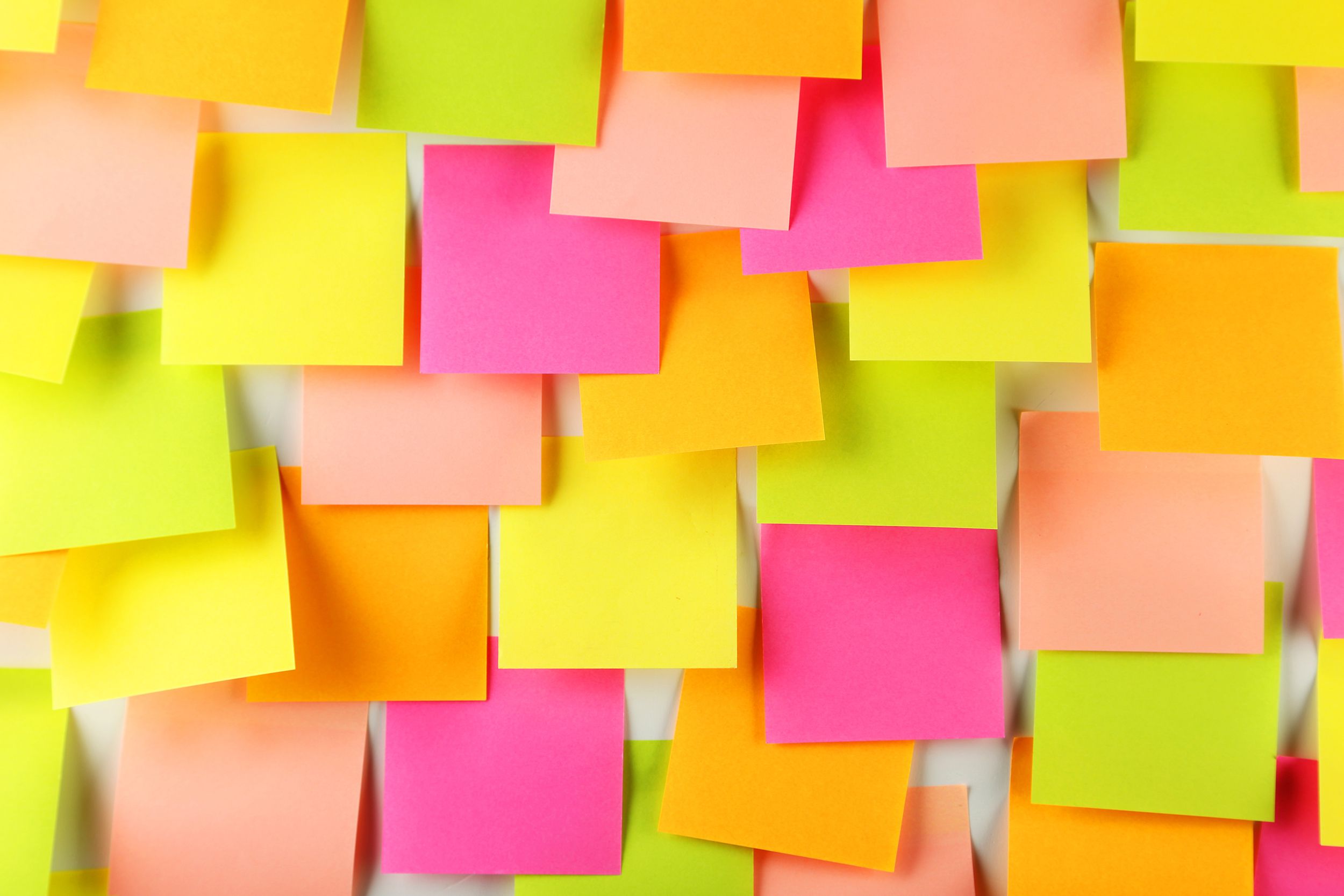 Wall completely filled with colorful neon Post-It notes
