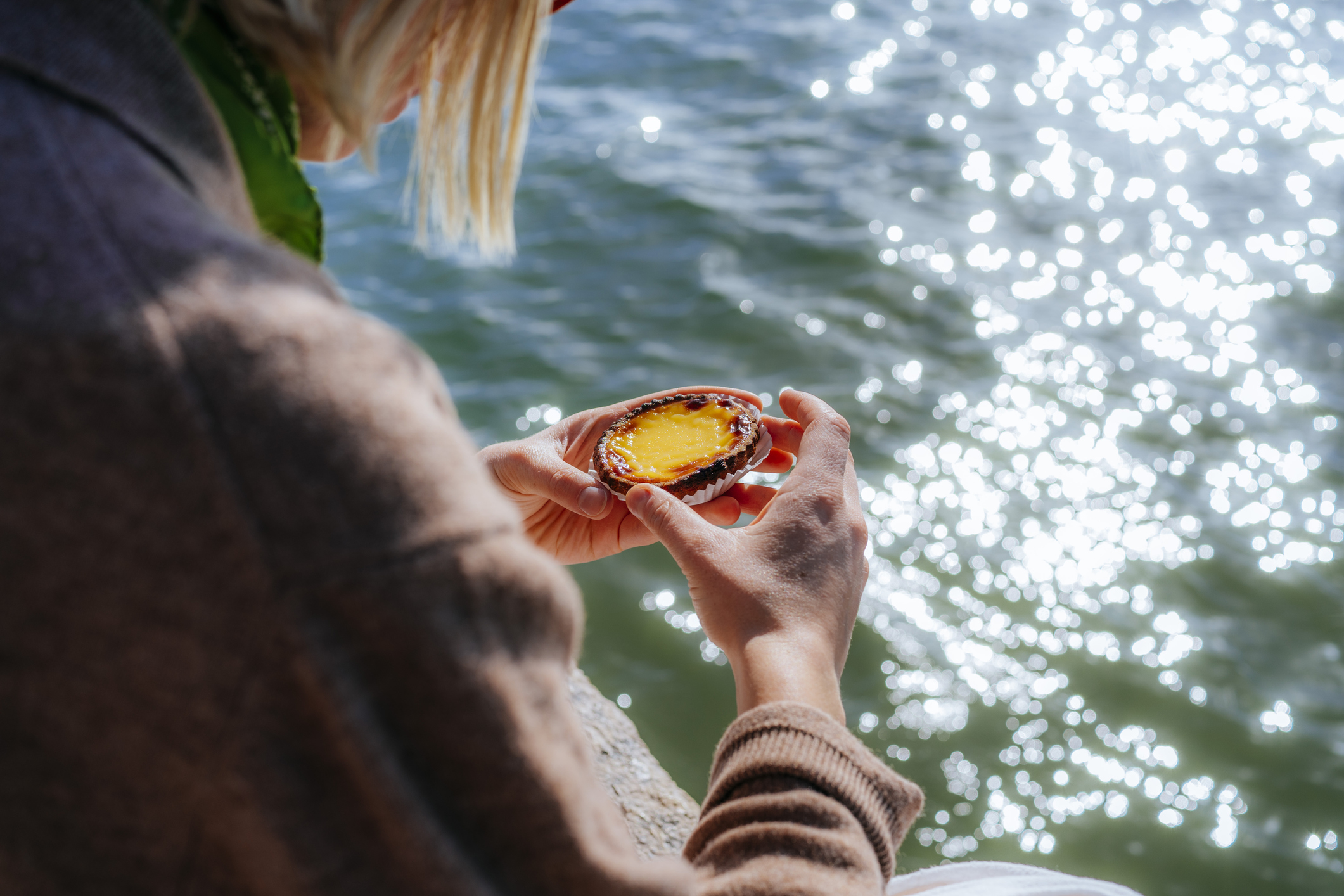 Woman Eating a Pastéis de Belém, Lisbon, Portugal