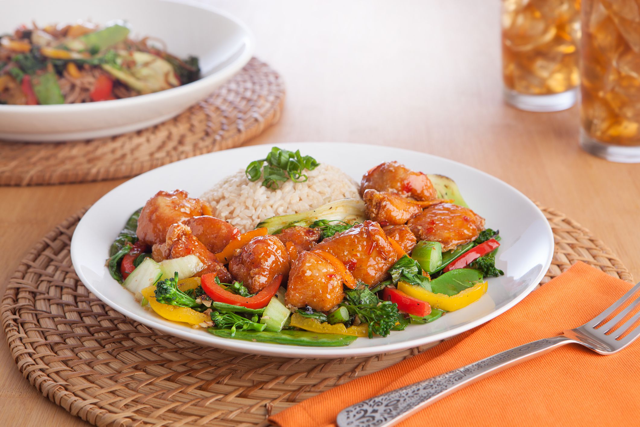 orange chicken over vegetables and rice