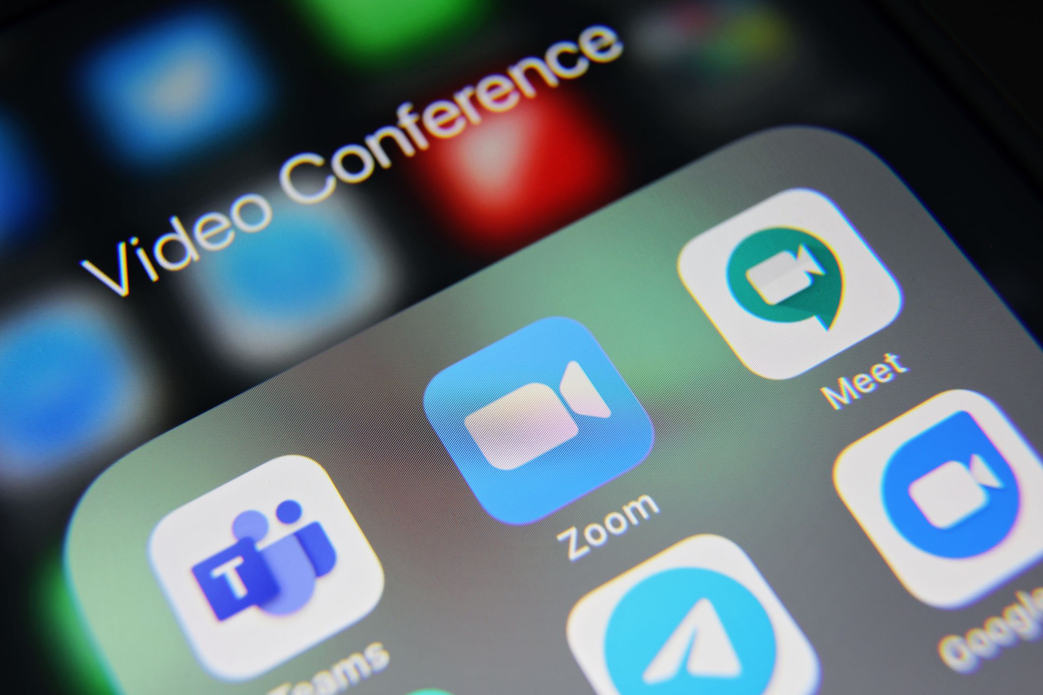 London, UK - 09 12 2020: Apple iPhone 6s screen with video conference social media icons applications Zoom, Microsoft Teams, Meet, Skype, Telegram, Twitter etc.
