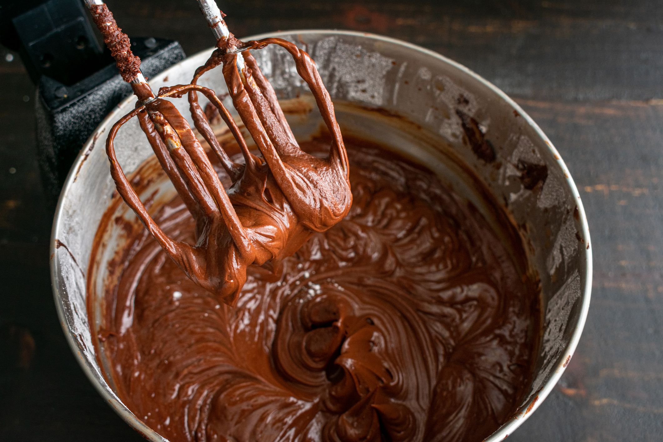 Chocolate cake icing that has just been made in an electric stand mixer