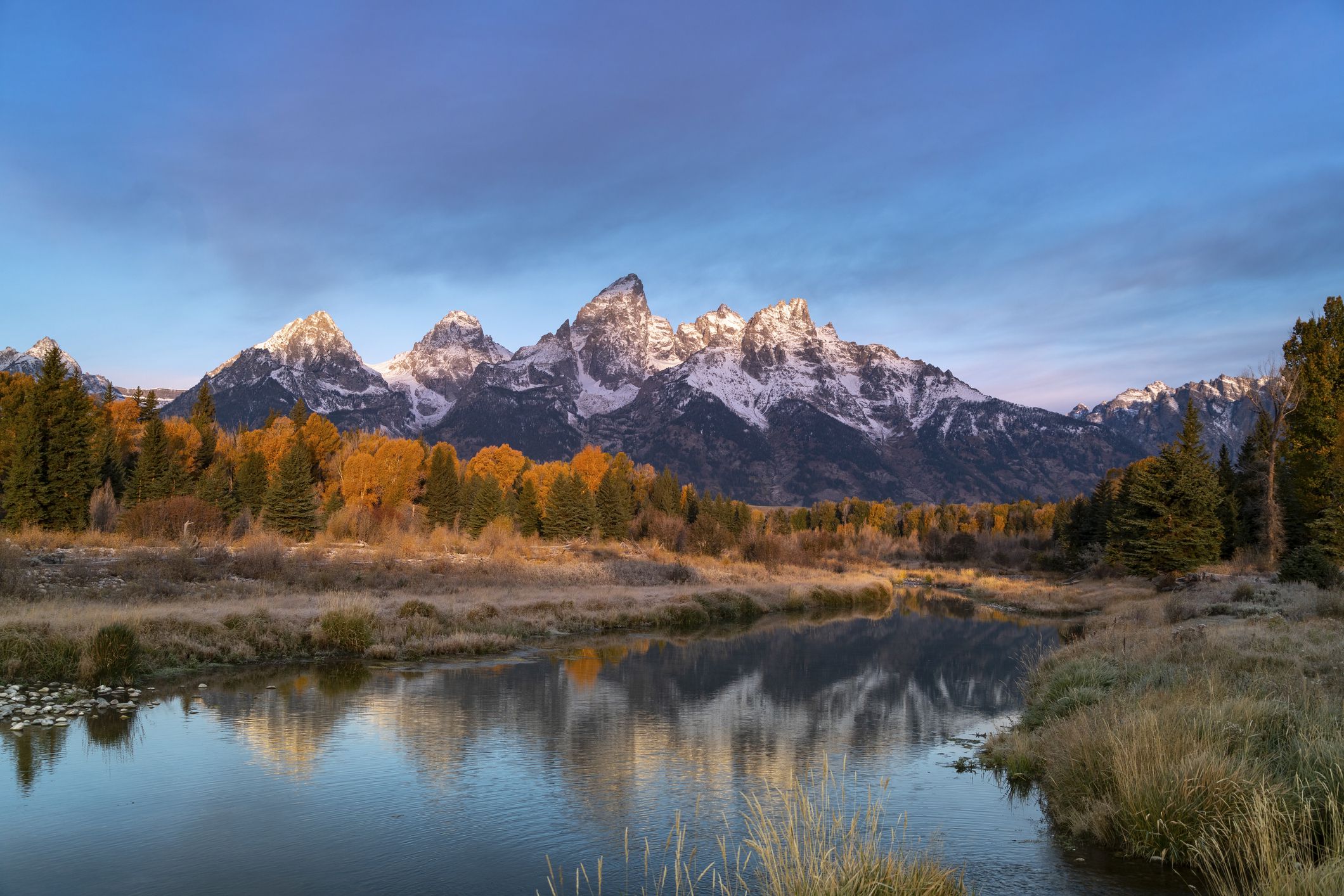 morning shot of grand teton after an autumn snowstorm from schwabacher landing in grand teton national park of wyoming, usa