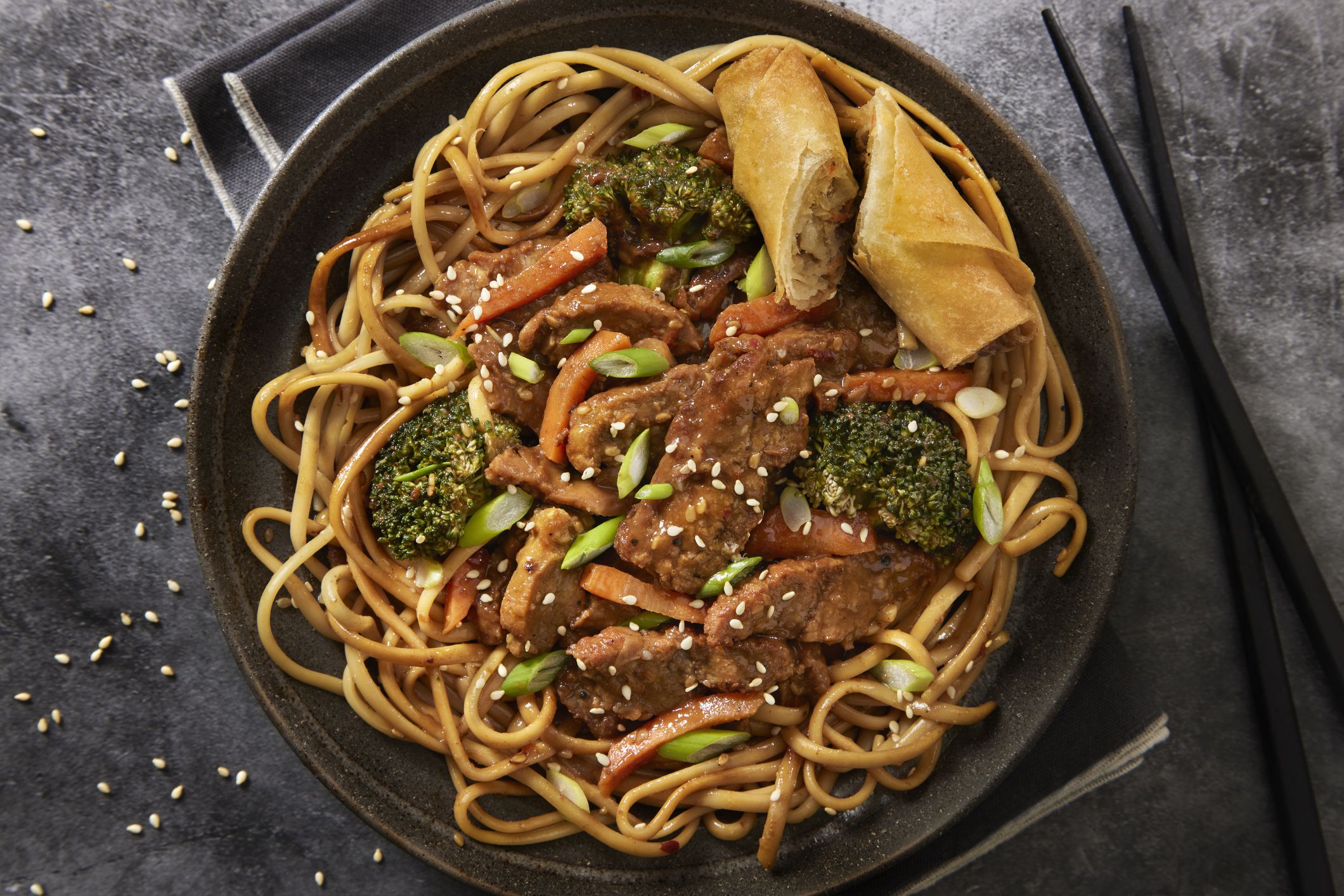 Szechuan Beef with Noodles, Mixed Vegetables and a Spring Roll