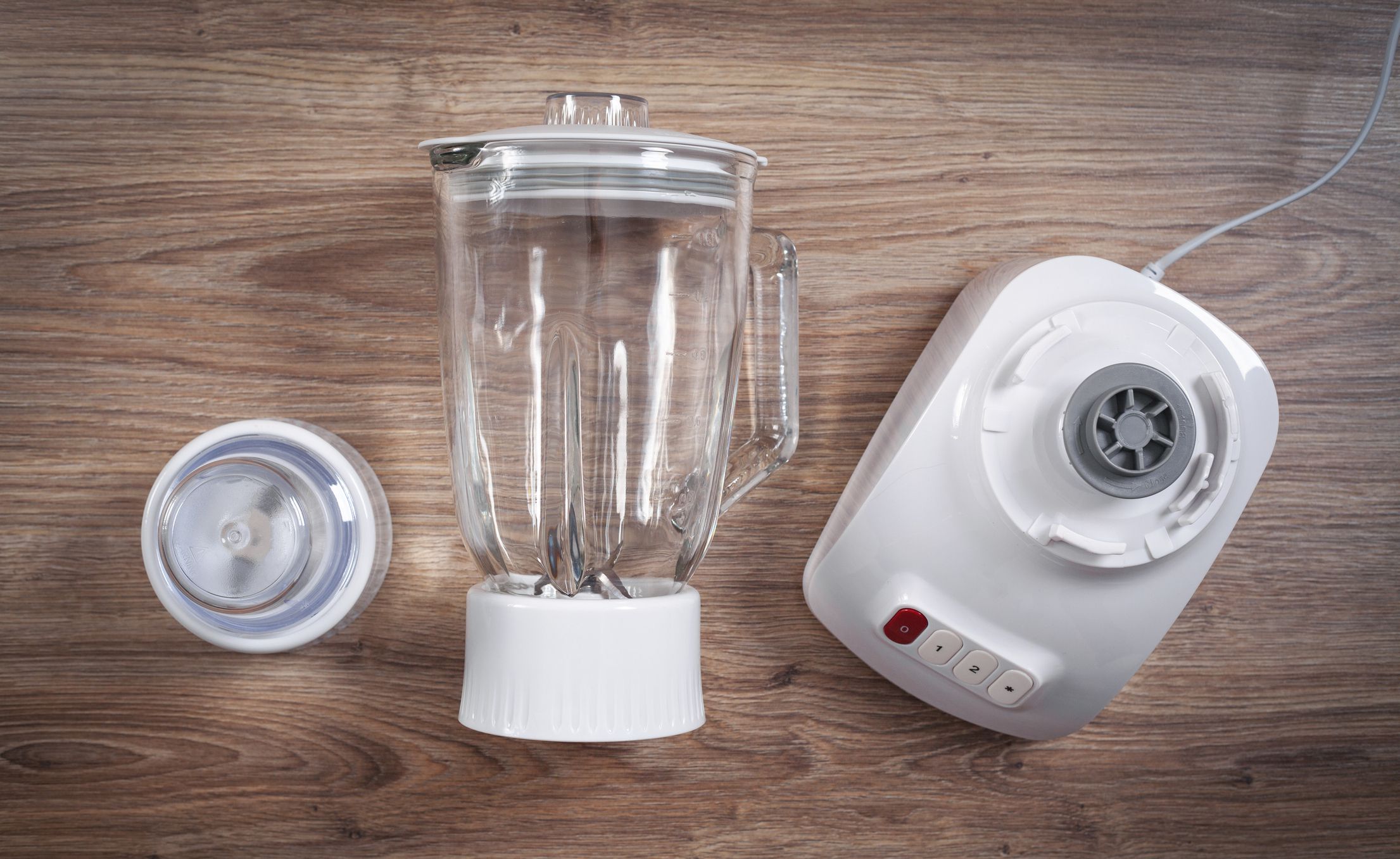 White electric blender on the wooden background.