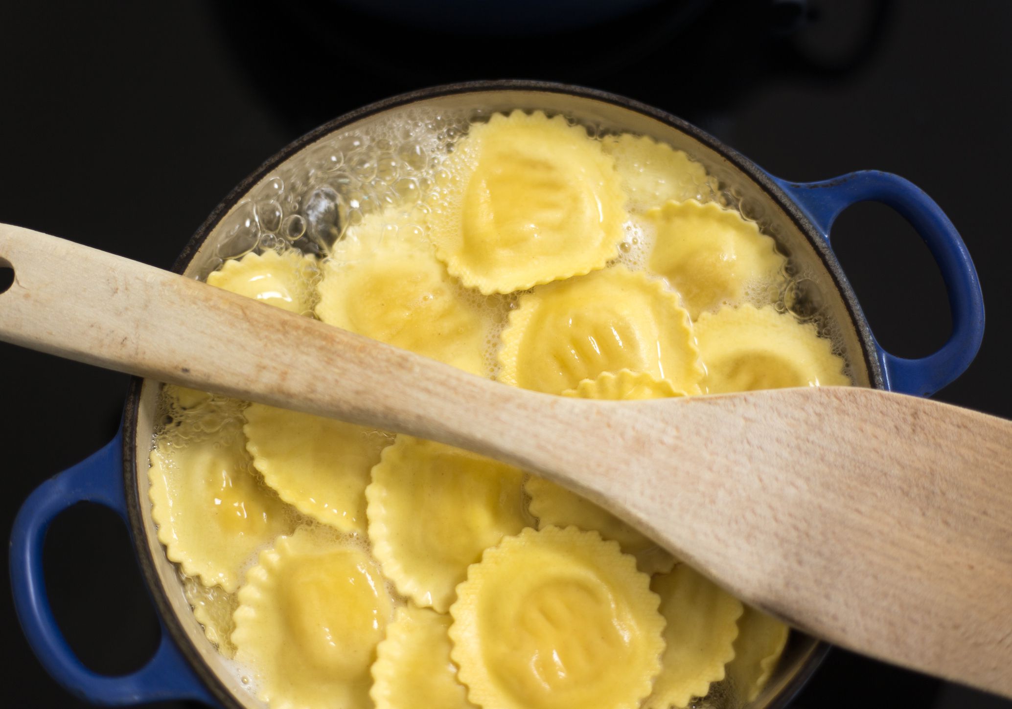 Pot of Boiling Ravioli with Wooden Spoon, Induction Stovetop