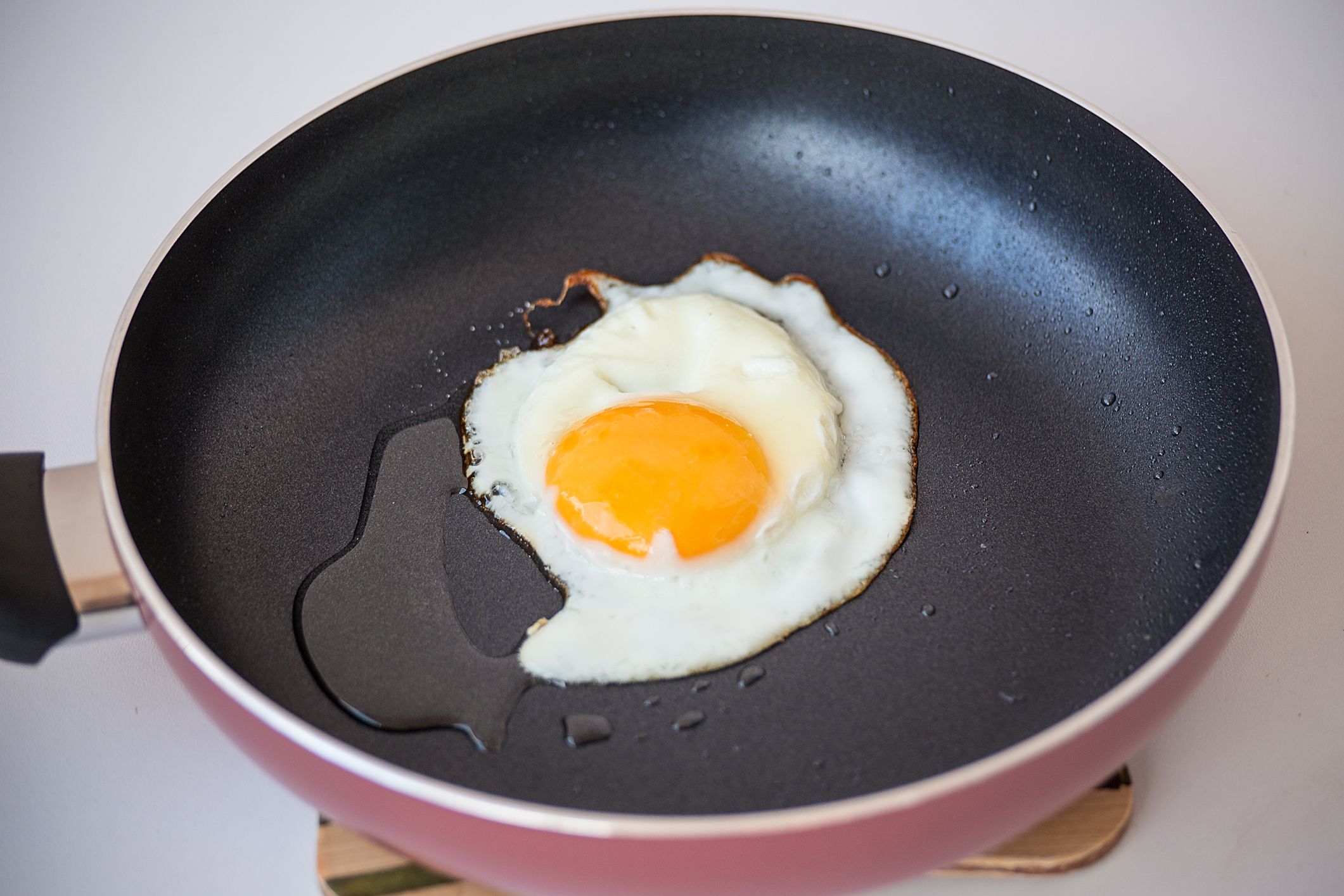 One fried egg on the frying pan with sunflower oil