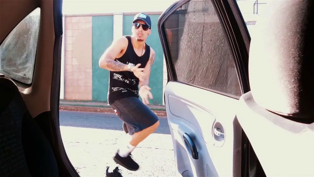 Screenshot of a person doing the Kiki Challenge dancing next to a moving car