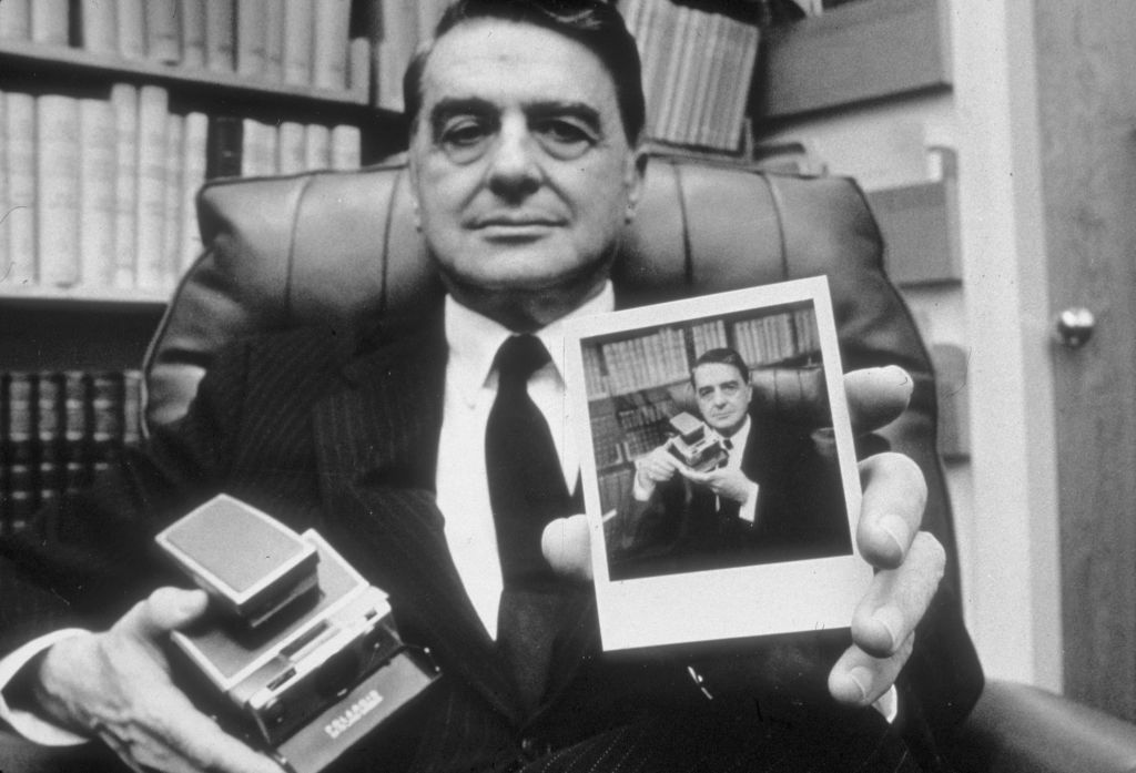 November 1972: Portrait of Dr. H. Edwin Land, President and Director of the Polaroid Corporation, holding a portrait of himself posing with the Sx-70 Polaroid camera in his office, Cambridge, Massachusetts.