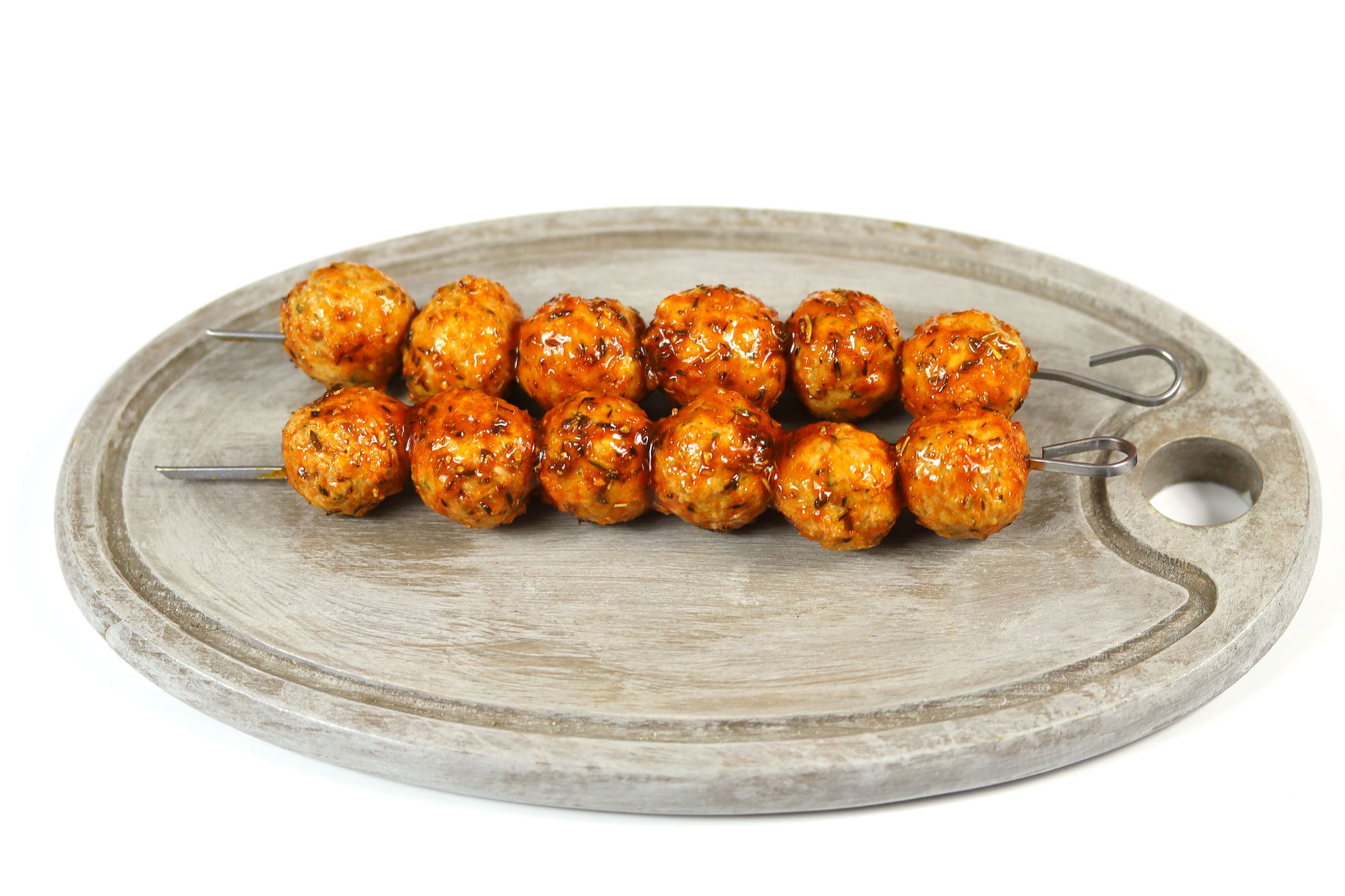 skewers of chopped and raw chicken on a white background