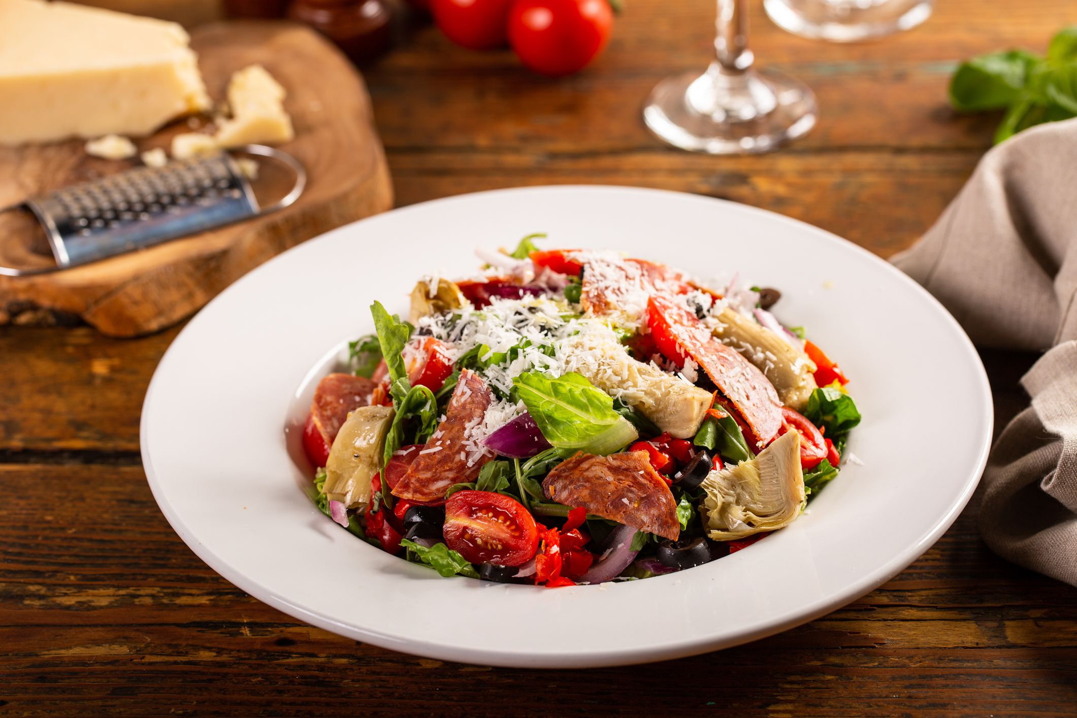 Italian antipasto salad with vegetables, salami, artichoke hearts and olives