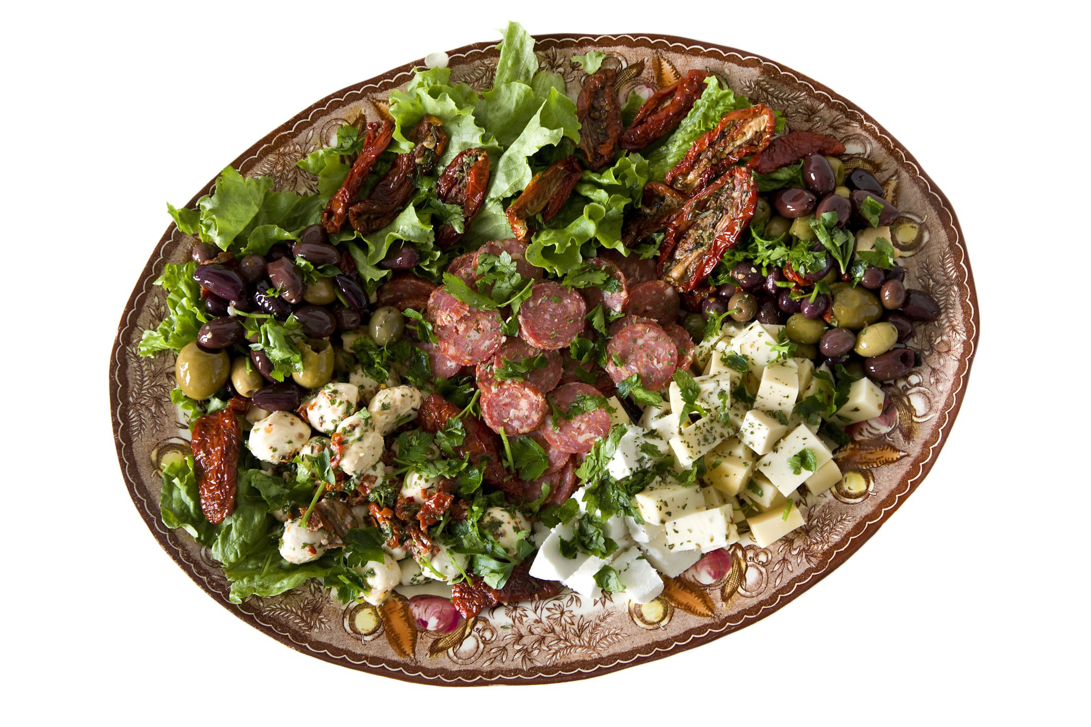 Italian antipasto on a plate with Olives, Cheese, dried tomatoes, and salami. Clipping path.