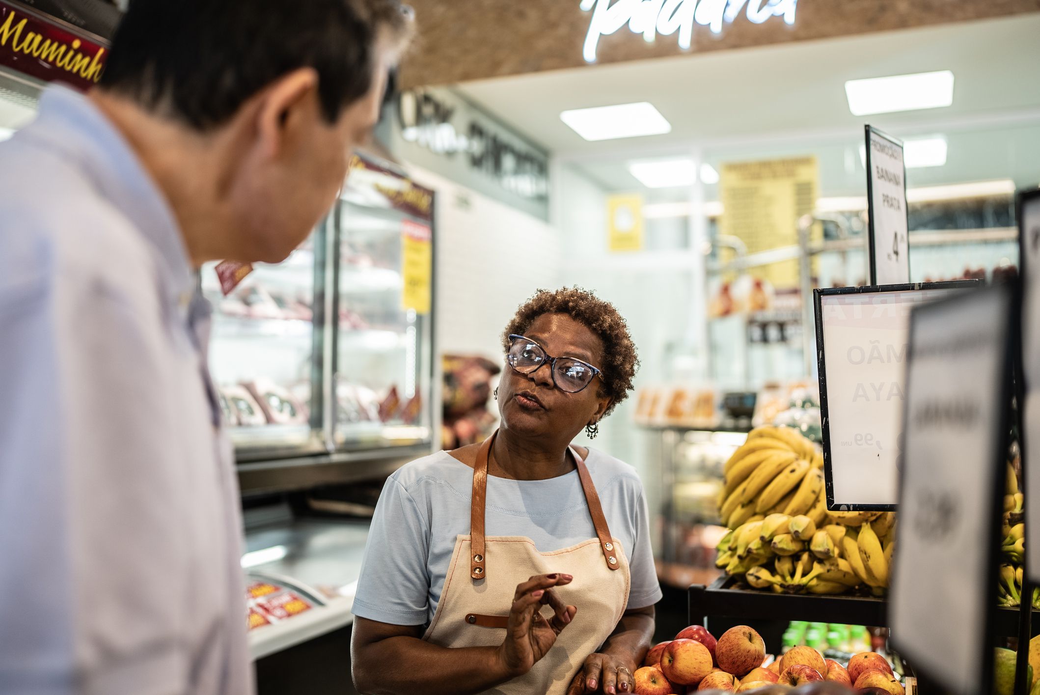 Saleswoman helping a customer in a supermarket