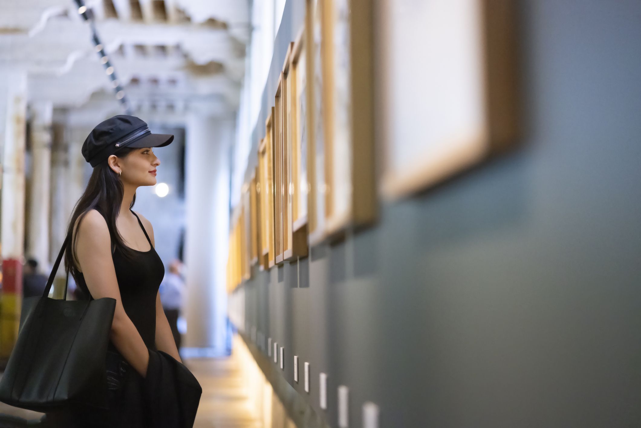 Young woman appreciating works of art in the museum