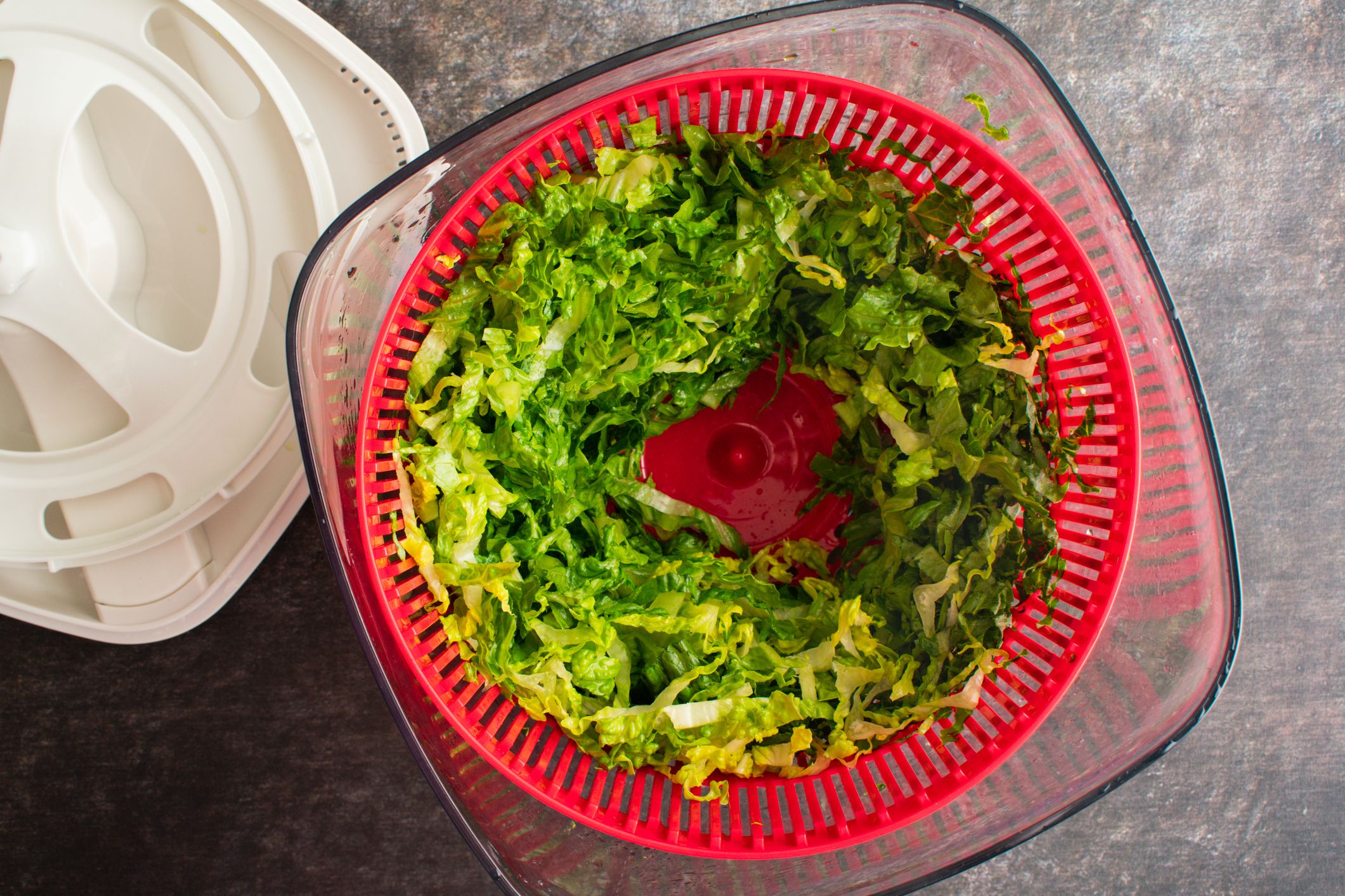 Thinly sliced hearts of romaine n a salad spinner bowl