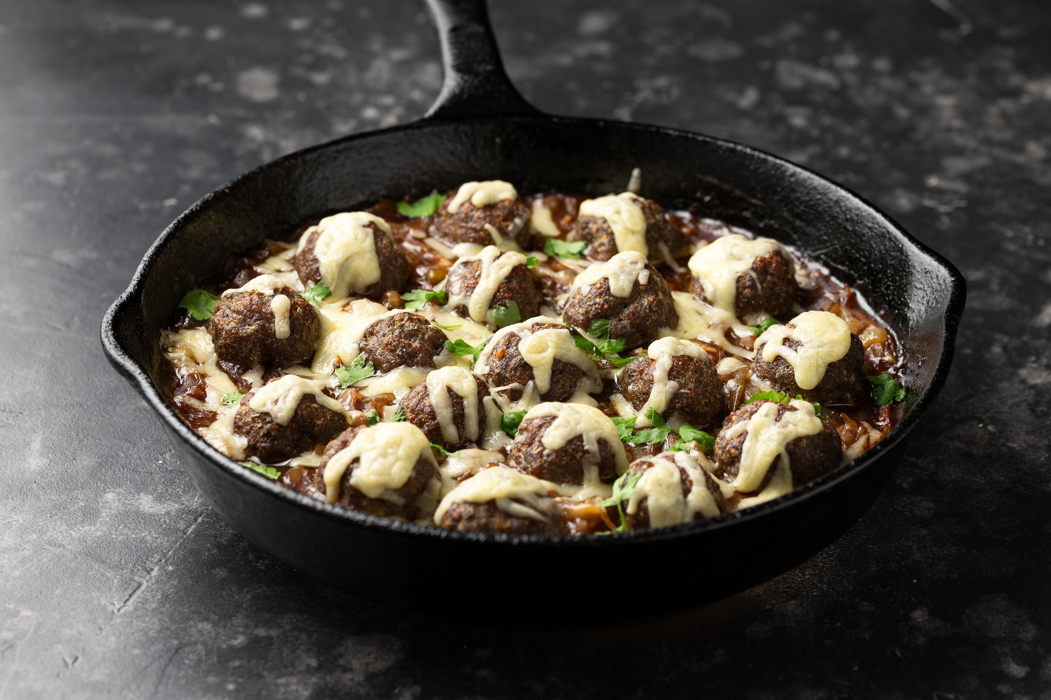 French onion beef meatballs in iron cast pan