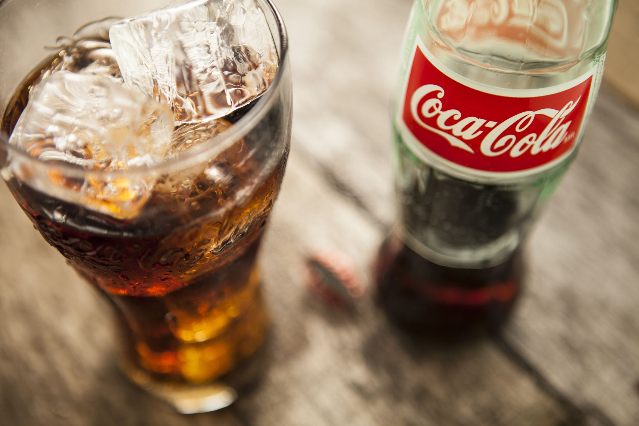 Lake Hopatcong, USA - December 13, 2012 Coca-Cola bottle and glass on picnic table