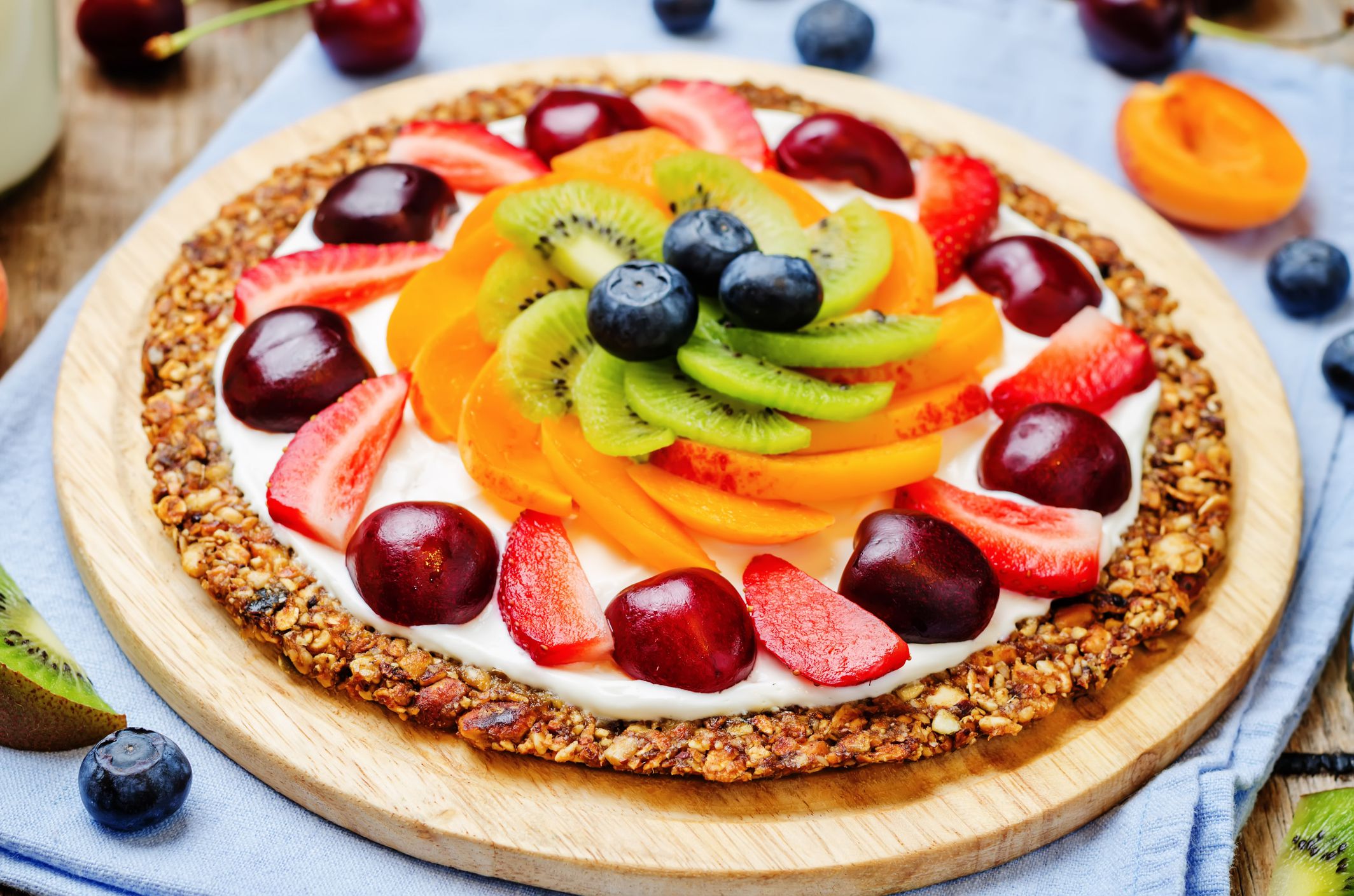 Greek yogurt granola fruit breakfast pizza. toning. selective focus