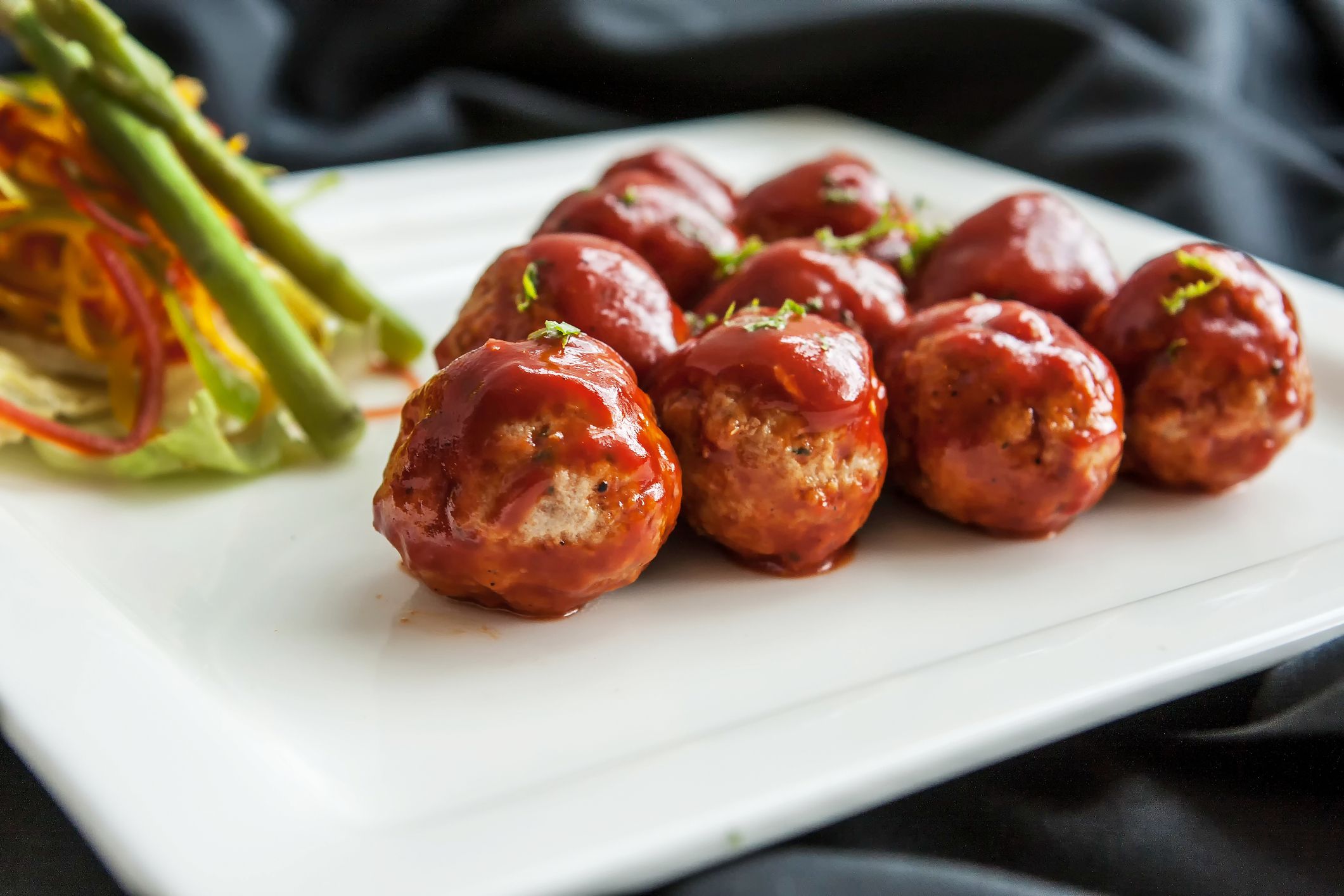 A ground meat rolled into a small size ball along with other ingredients cooked by steaming, frying, baking, with different kind of sauce