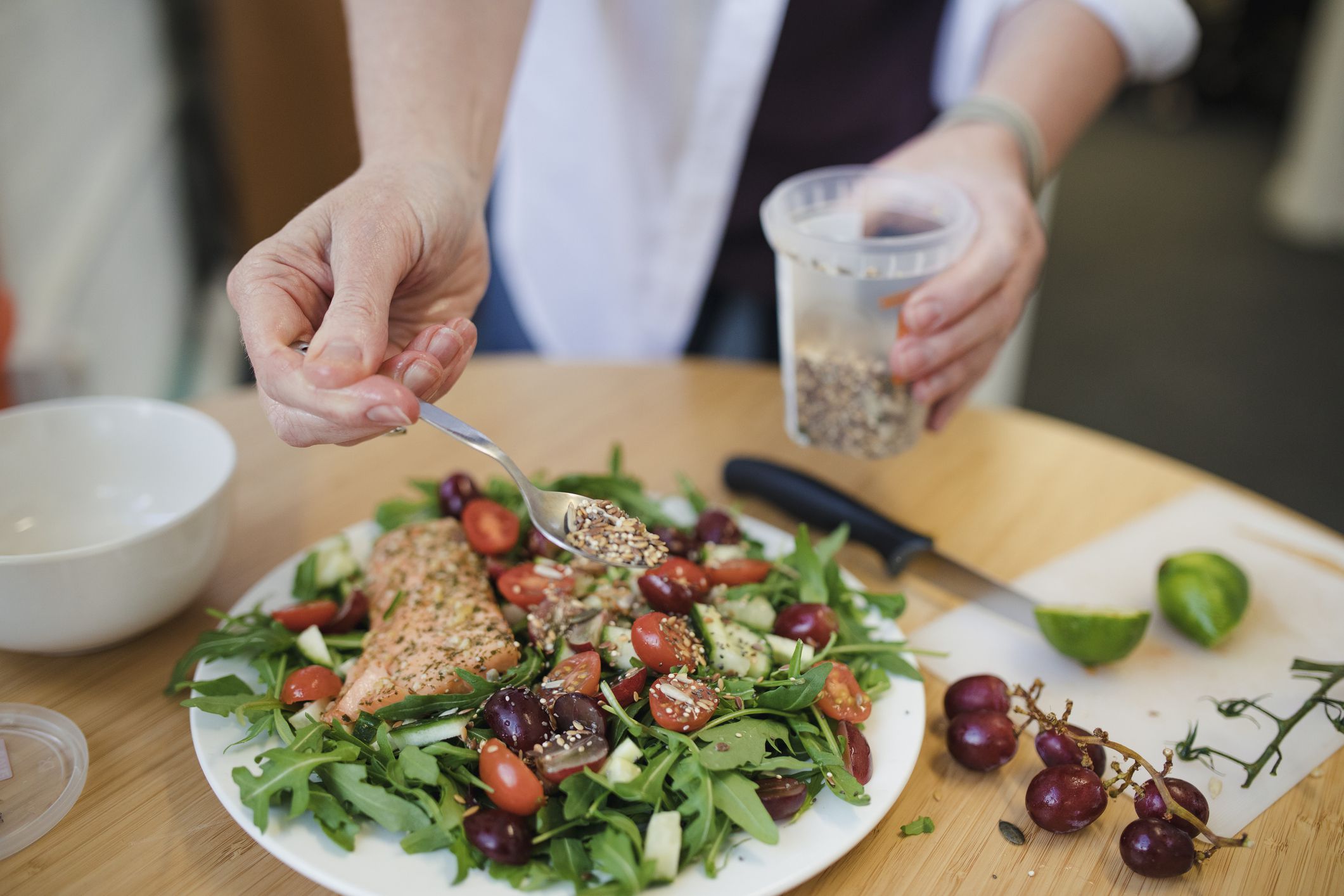 A mid adult woman prepares her lunch in the office.