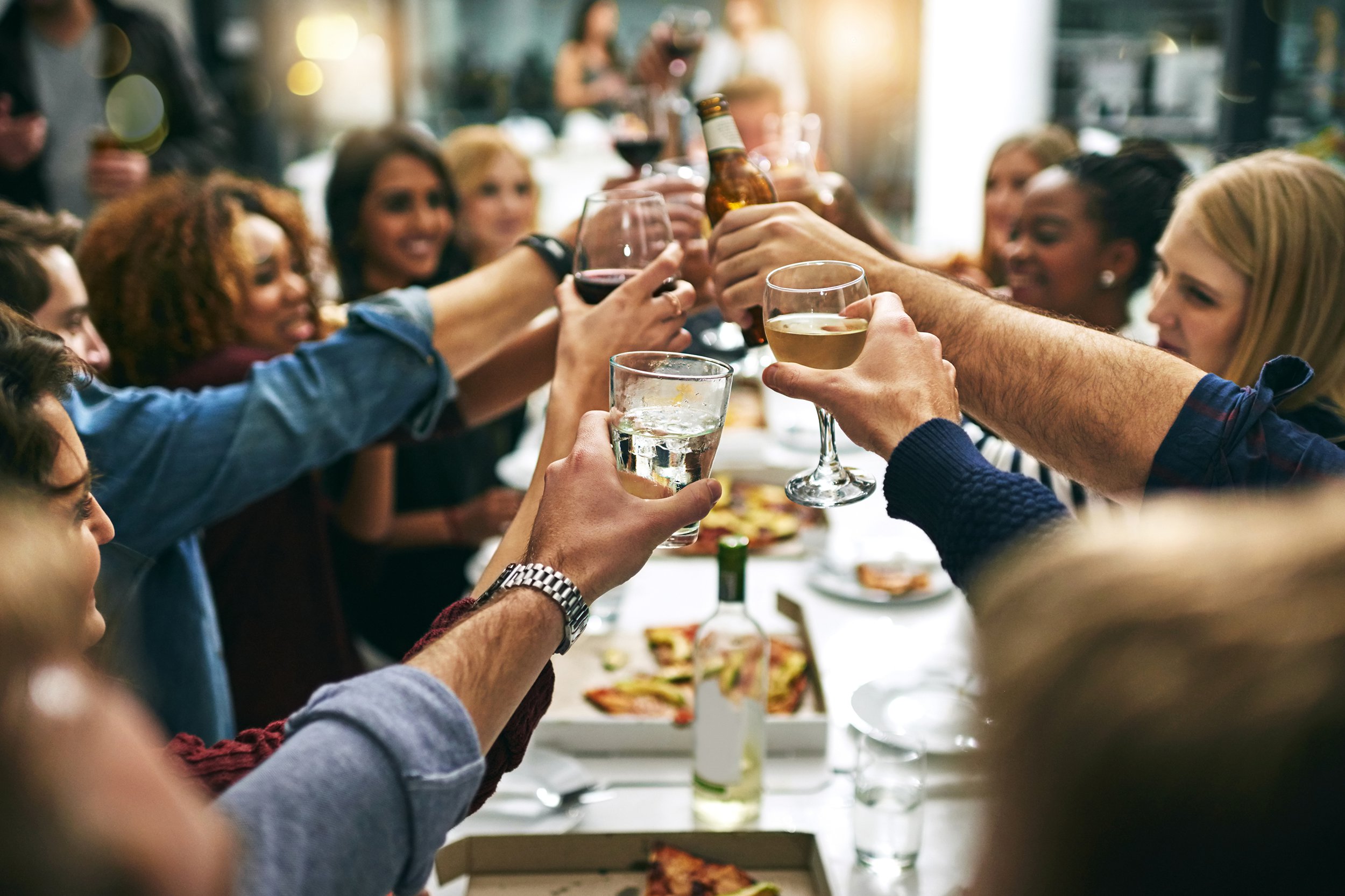 Dinner party guests toasting at a restaurant