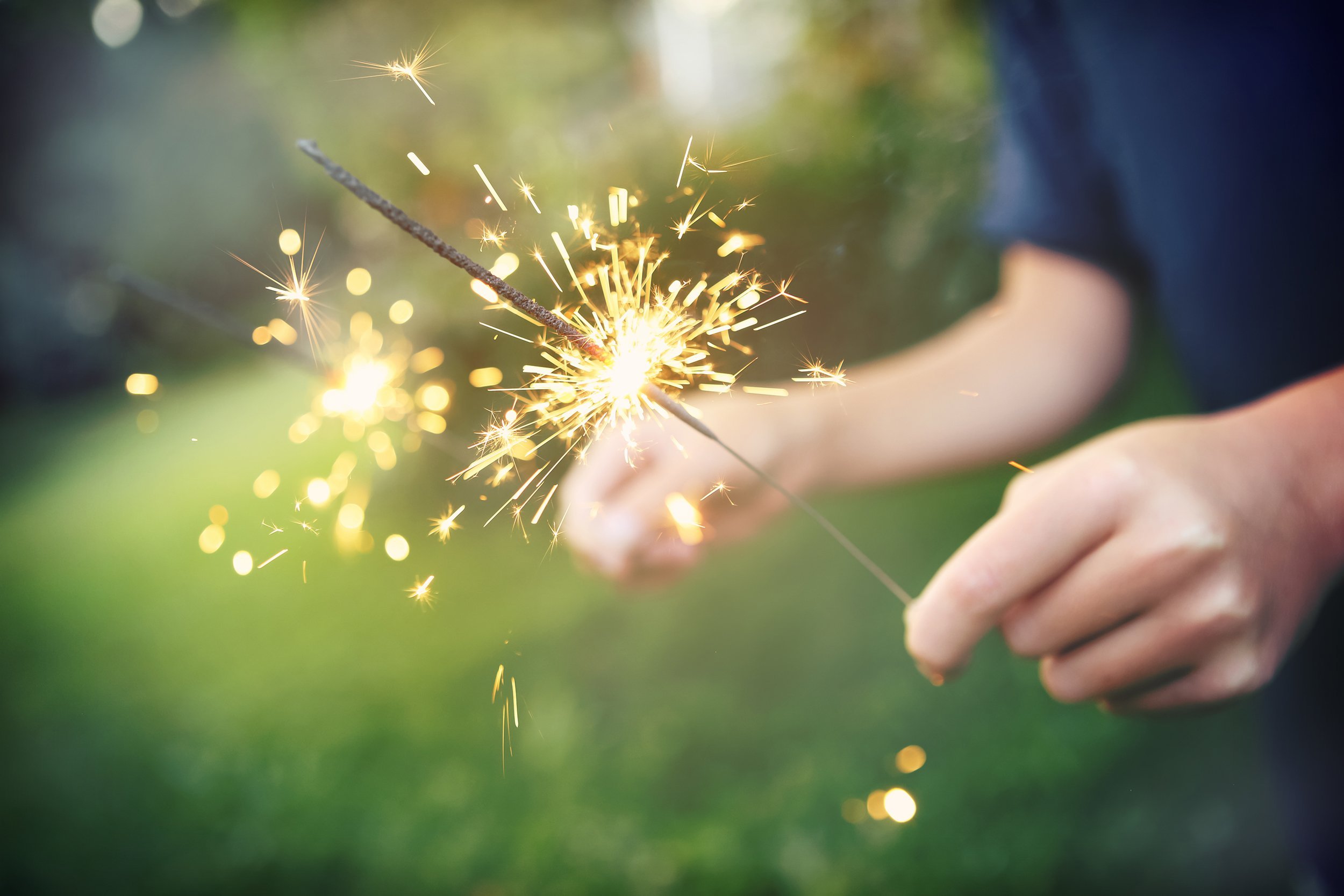 child holding sparklers