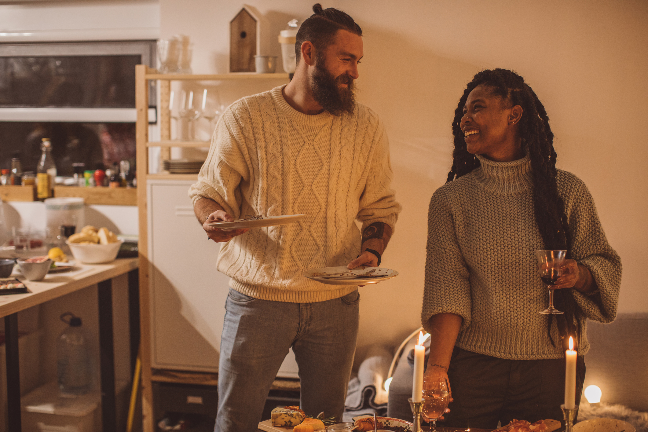 Couple Taking Dishes Into the Kitchen for Cleaning, Date Night at Home