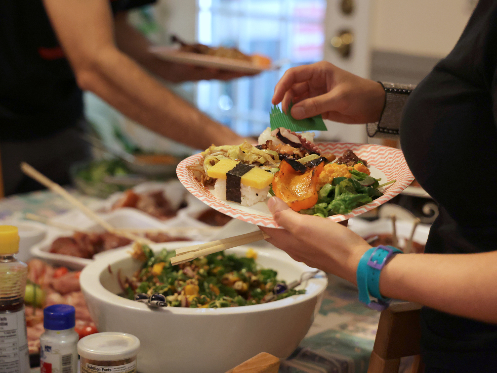 Dinner Guest With a Plate of Food at a Home Potluck