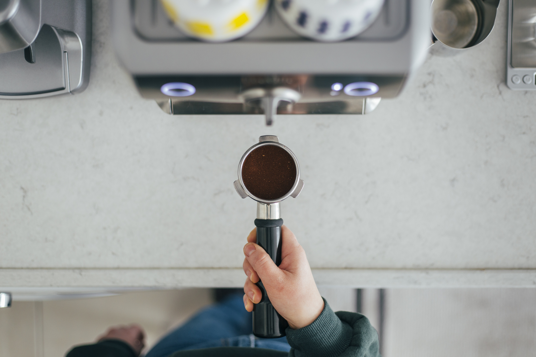 Top View of Woman Making Espresso in Coffee Maker at Home