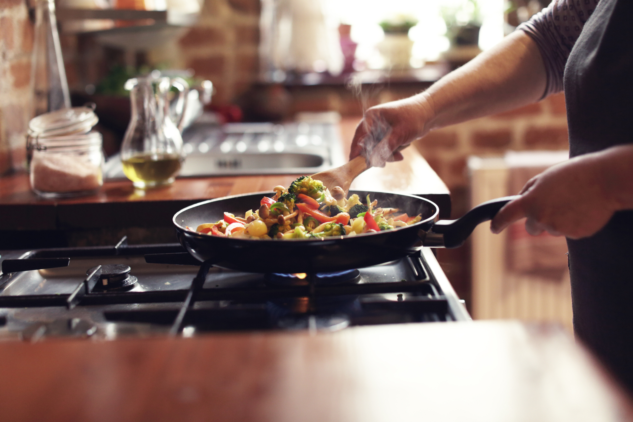 Focus on Person Cooking Chinese Vegetables on a Skillet
