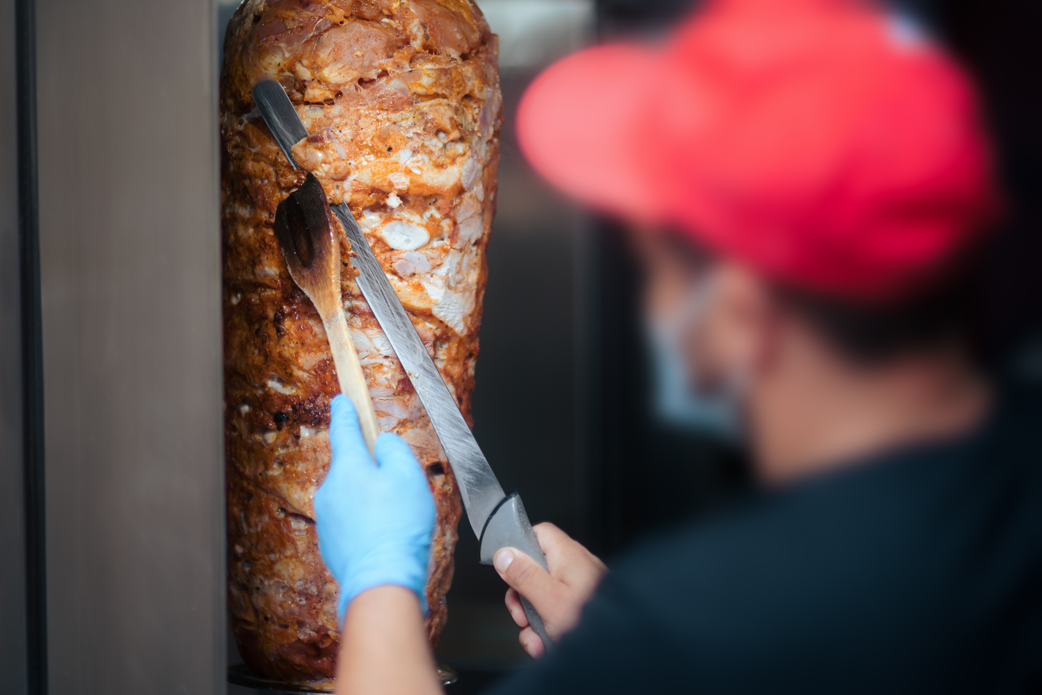 Chef Cutting Roasted Meat With Doner Knife