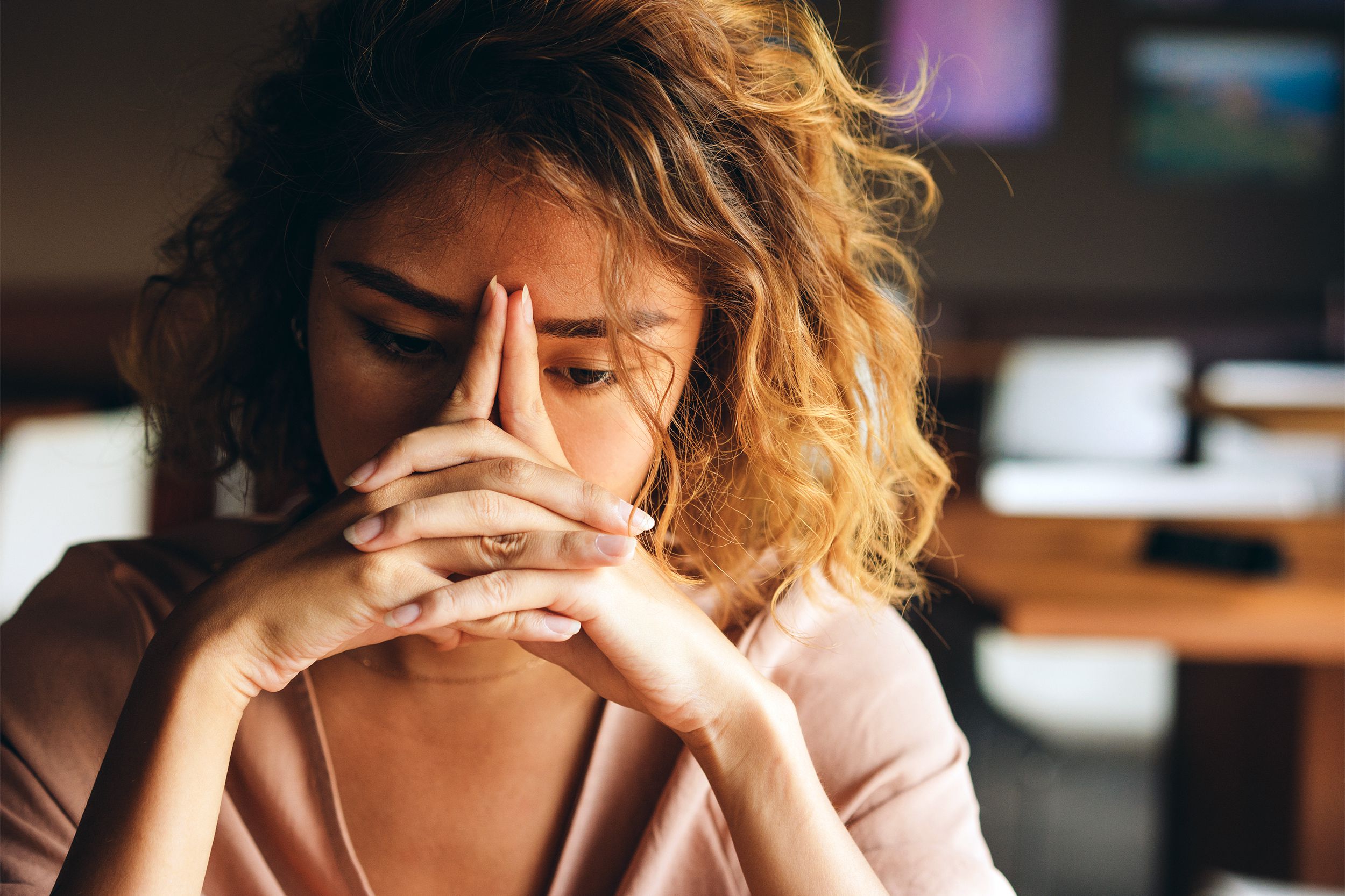 Woman looking stressed with fingers on her forehead