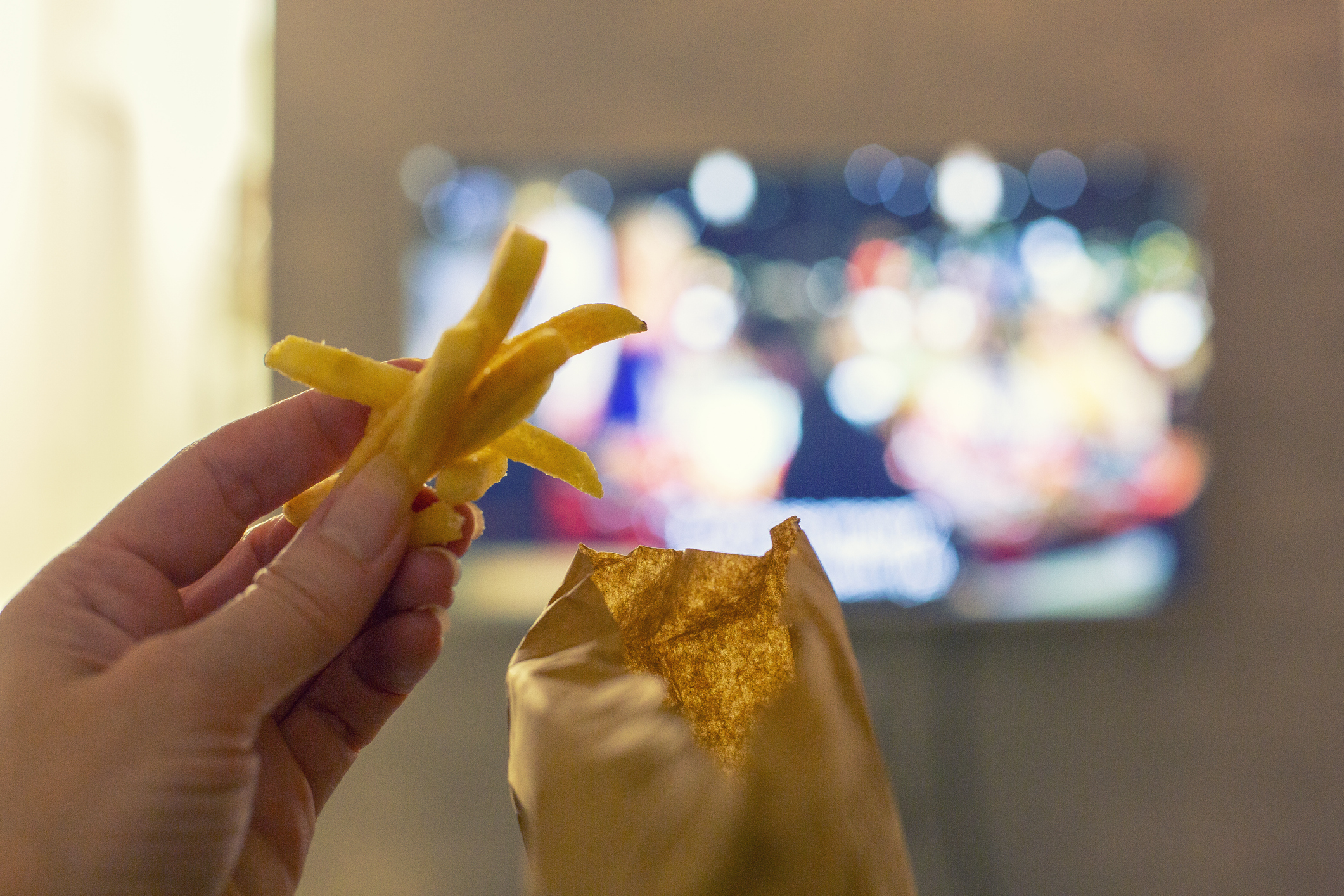 Hand With Fried French Fries