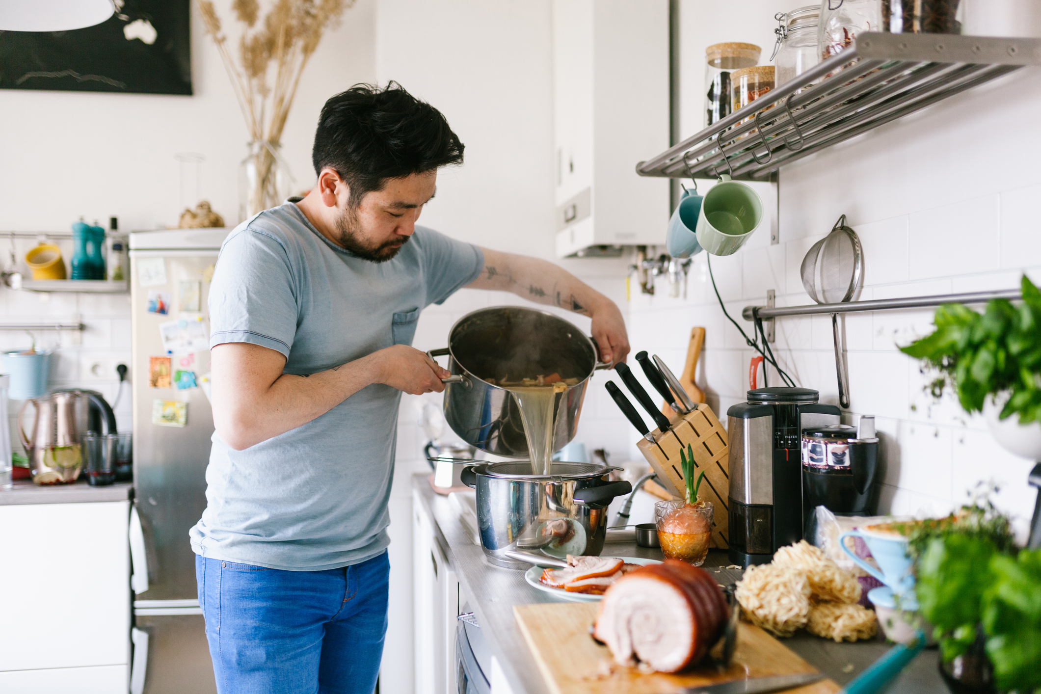 Man Making Ramen Broth in His Kitchen