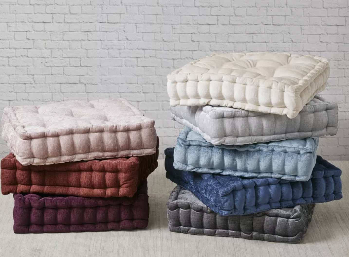 Floor cushions in several different colors in two stacks