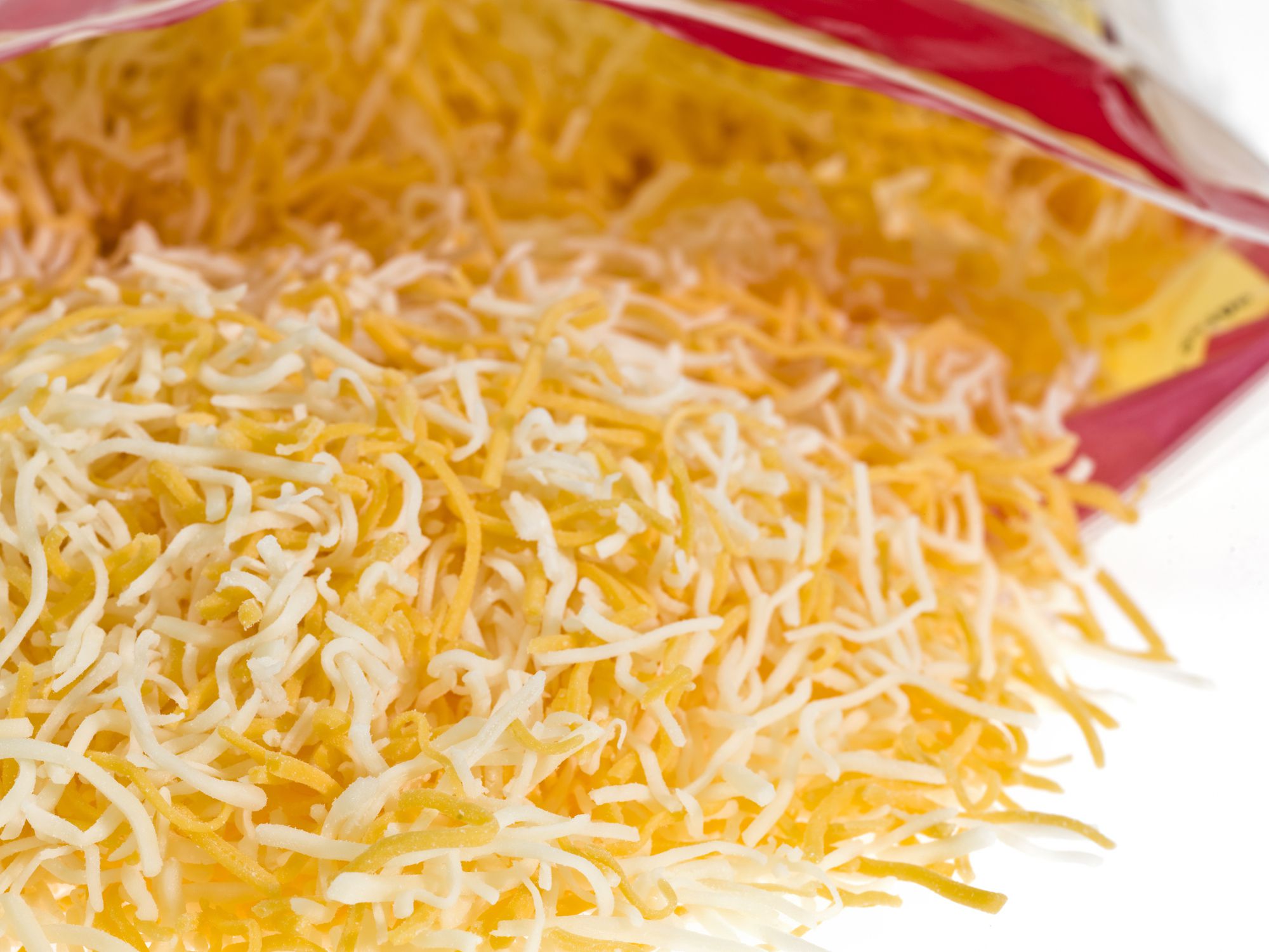 Mixed Shredded Cheese (monterey jack and cheddar cheeses) Coming out of the Bag. (this picture has been taken with a Hasselblad H3D II 31 megapixels camera)