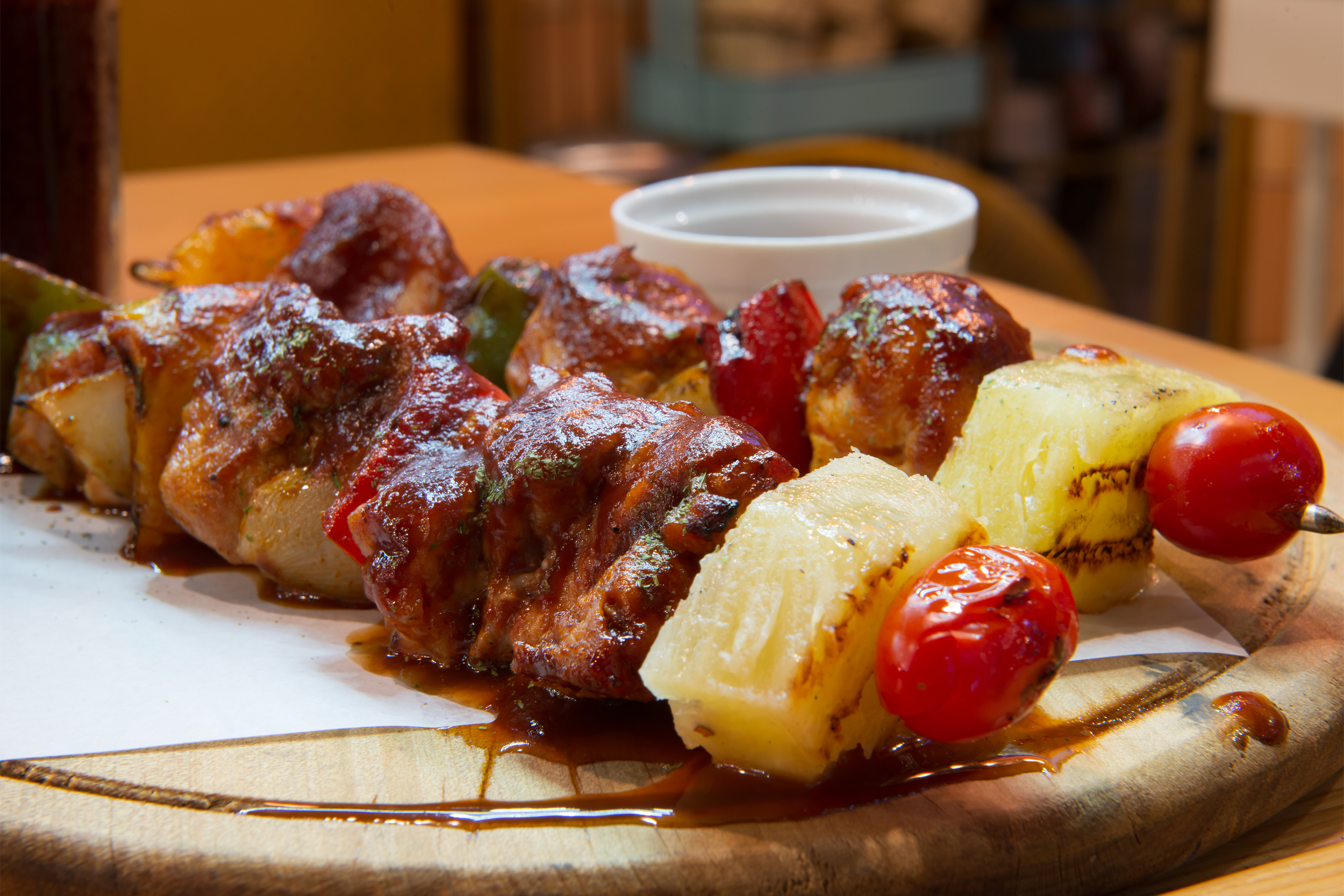 grilled pineapple, pork, tomato skewer