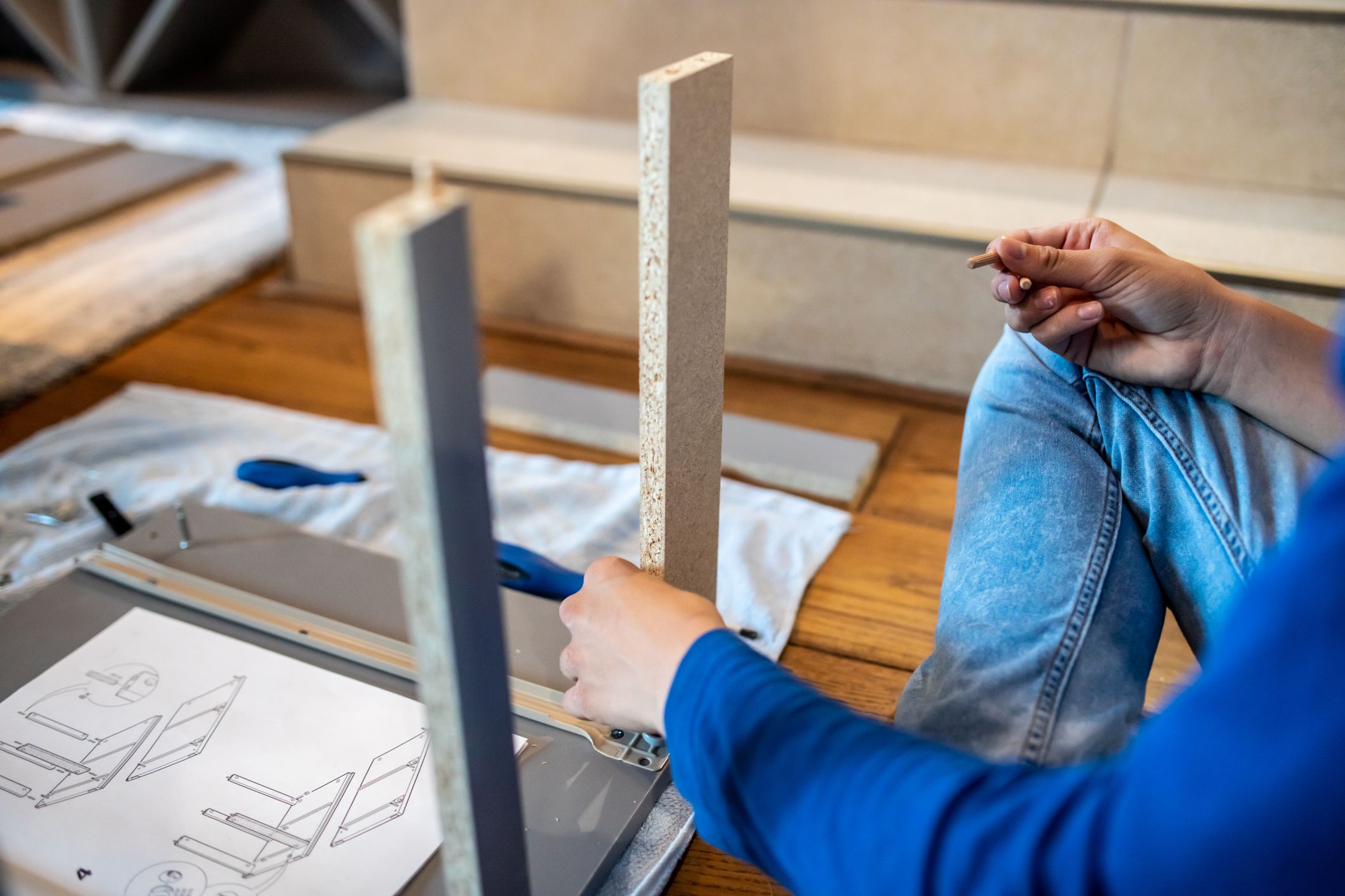 Teenager boy putting furniture together at home