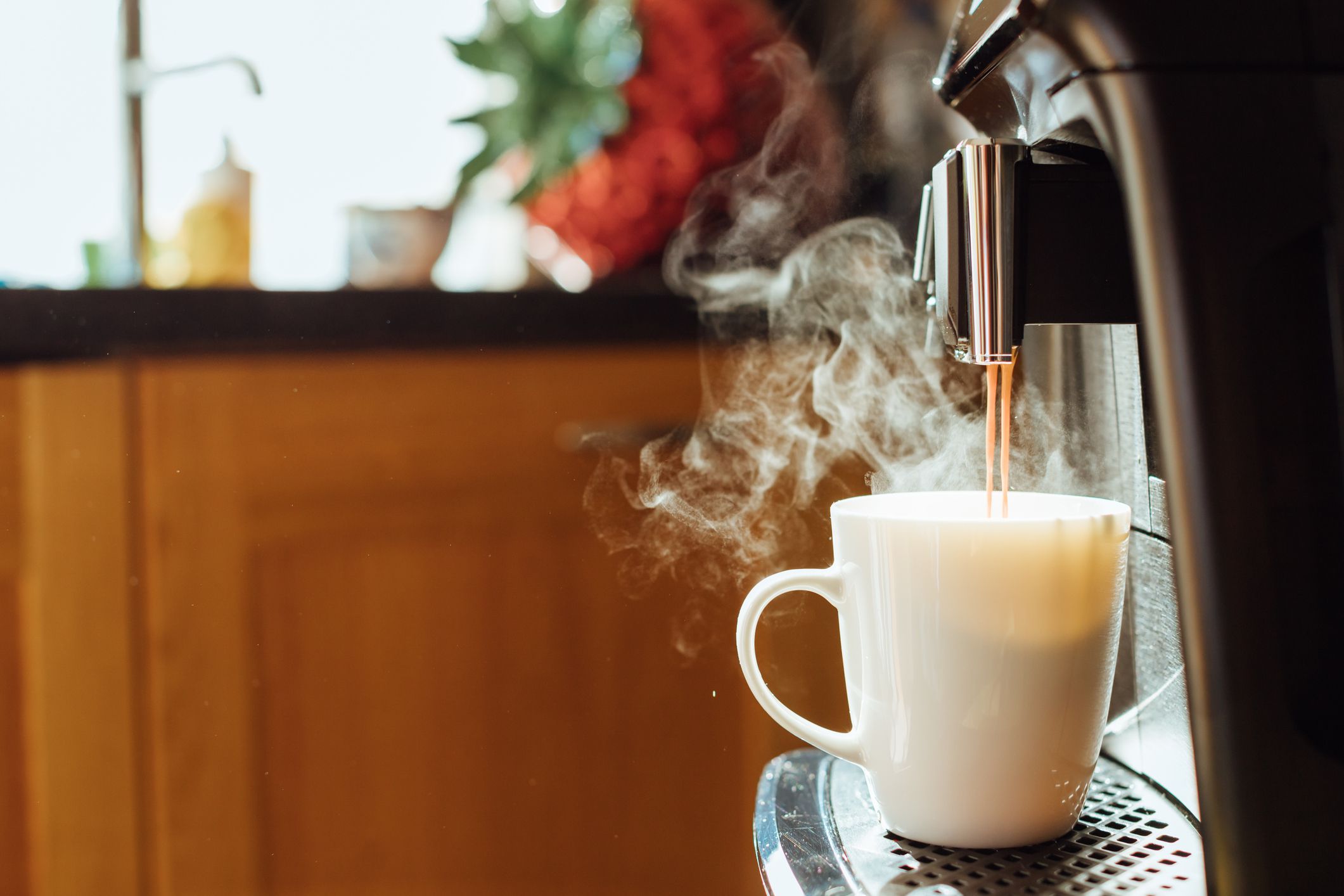 Close-up of coffee machine making steaming coffee on vintage kitchen. Picture of pouring coffee into a white mug. Early morning breakfast on rustic background, mockup (template) for designs