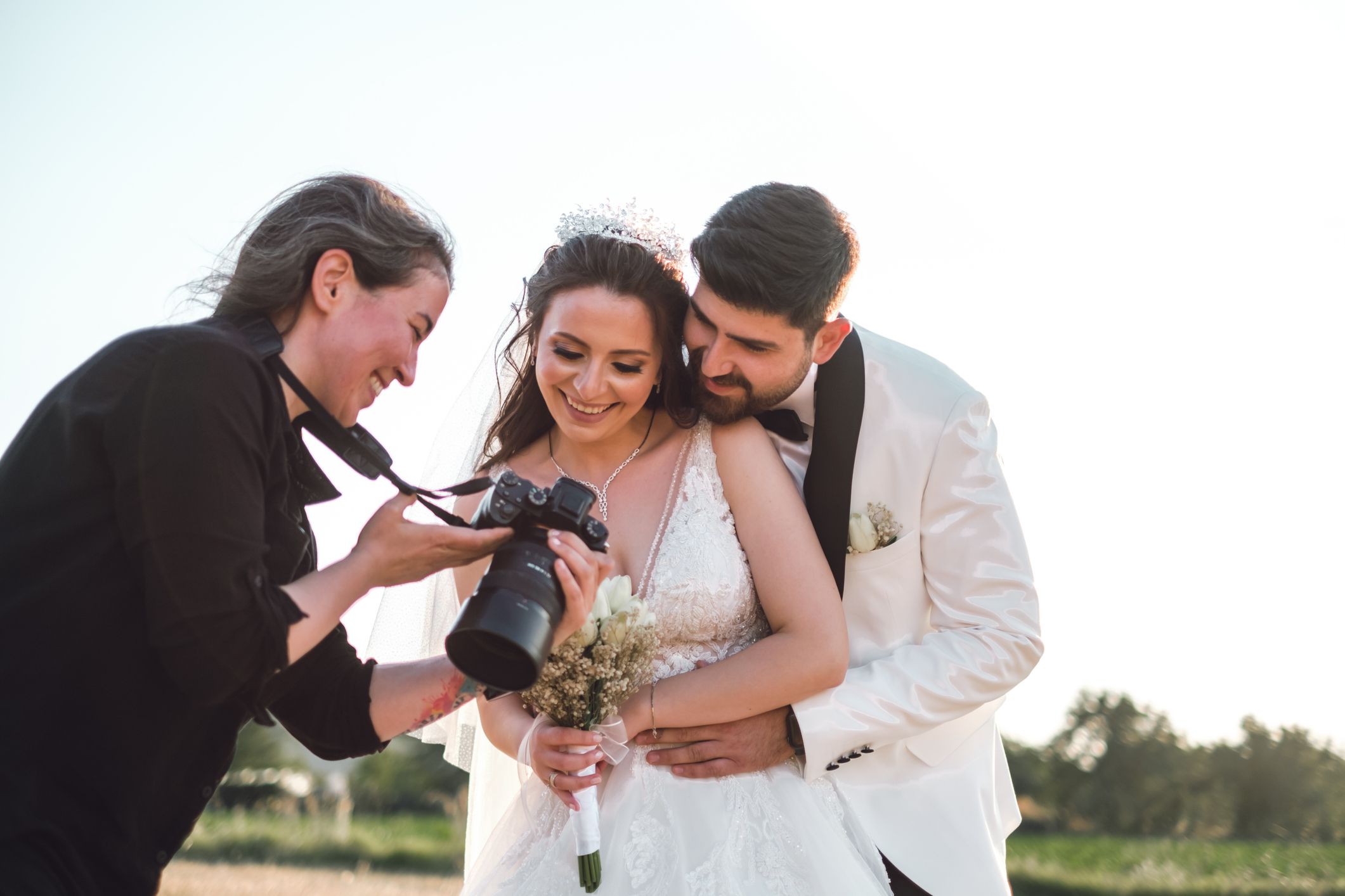 Wedding photographer with a profesional camera shooting bride and groom