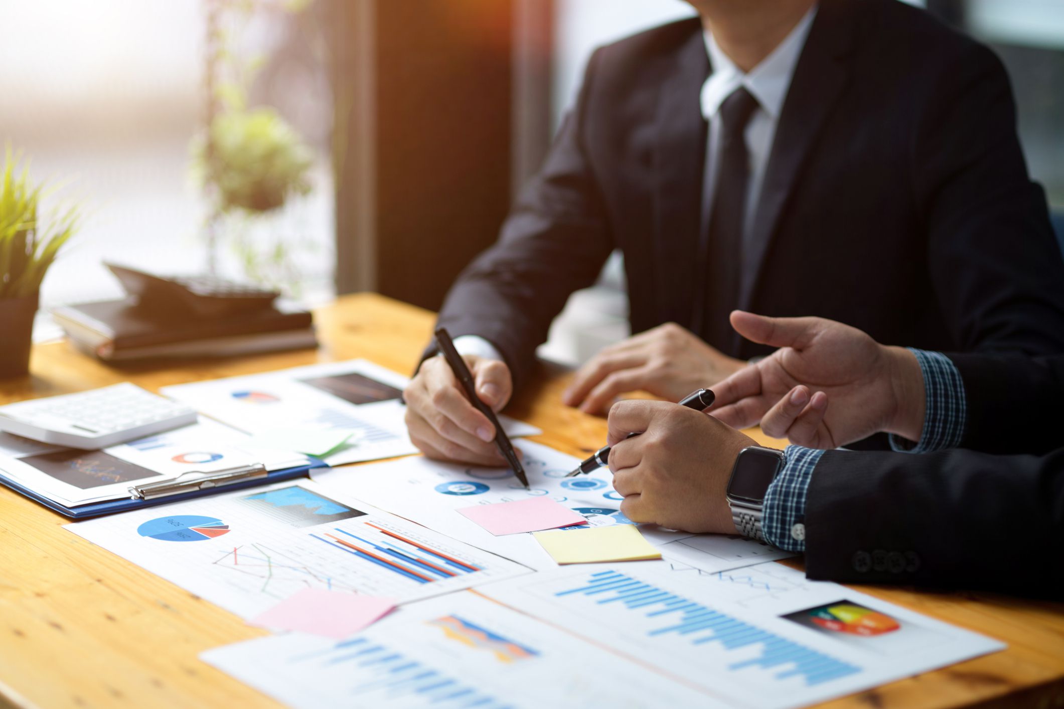 Cropped shot of a two professional male banker or financial investment analysts brainstorming and planning the new project together.