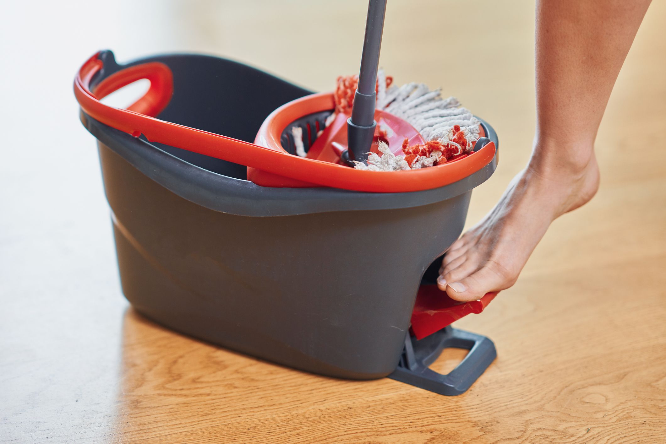 Picture of bucket and mop on the wooden floor. High quality photo