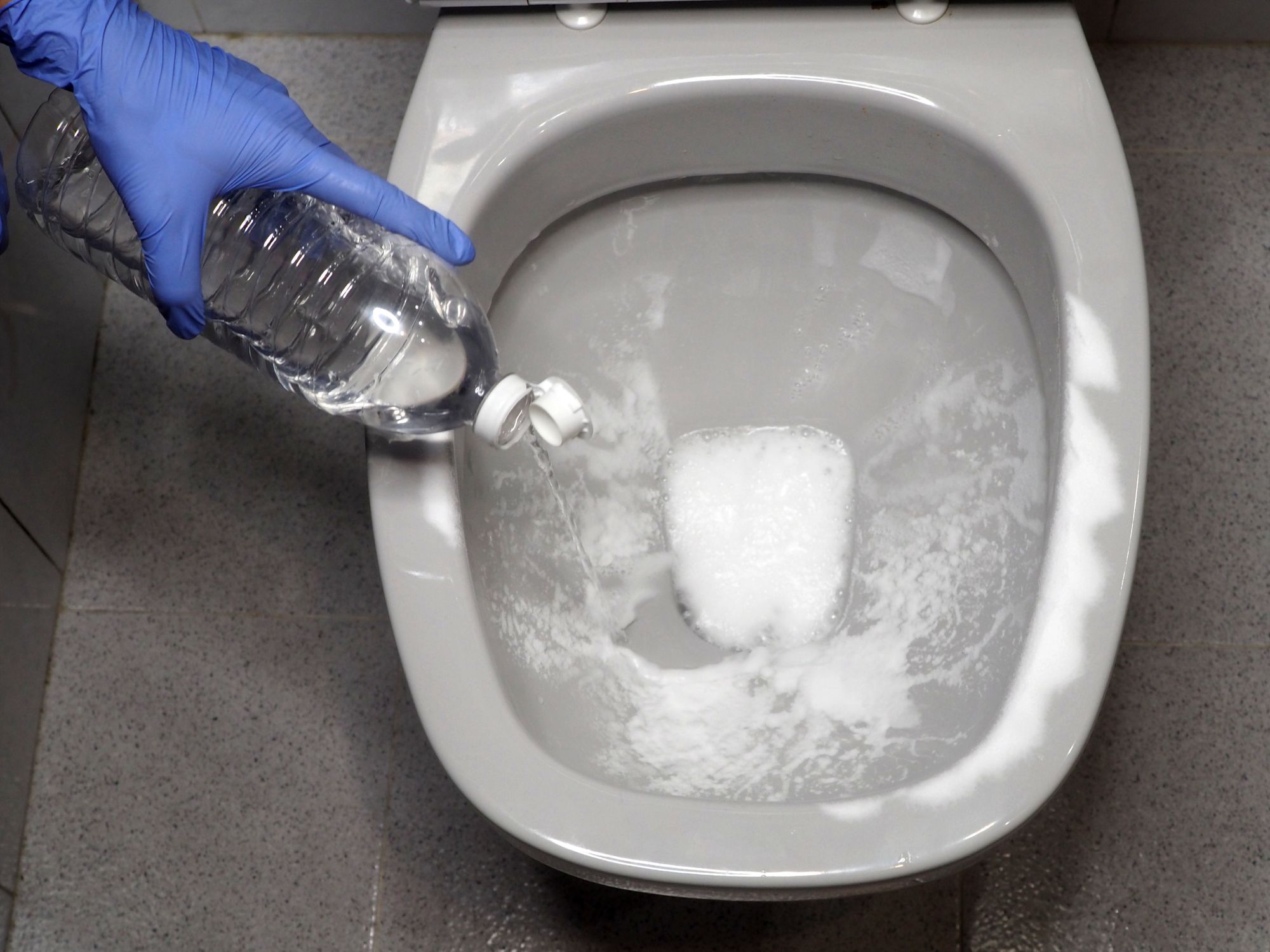 Sanitizing the toilet bowl with baking soda and vinegar. Ecological house cleaning. View from above.