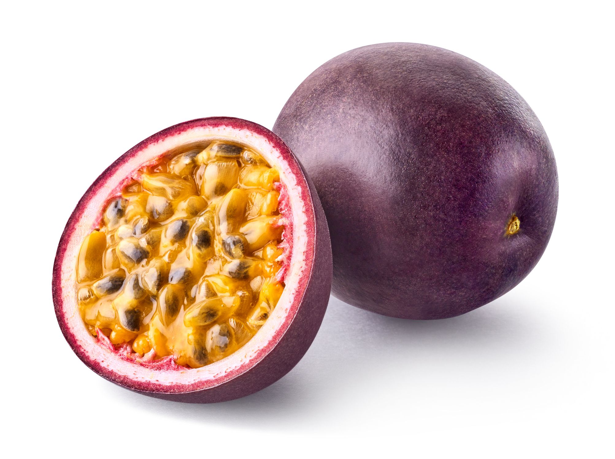 Whole and half fresh ripe passion fruit isolated on white background