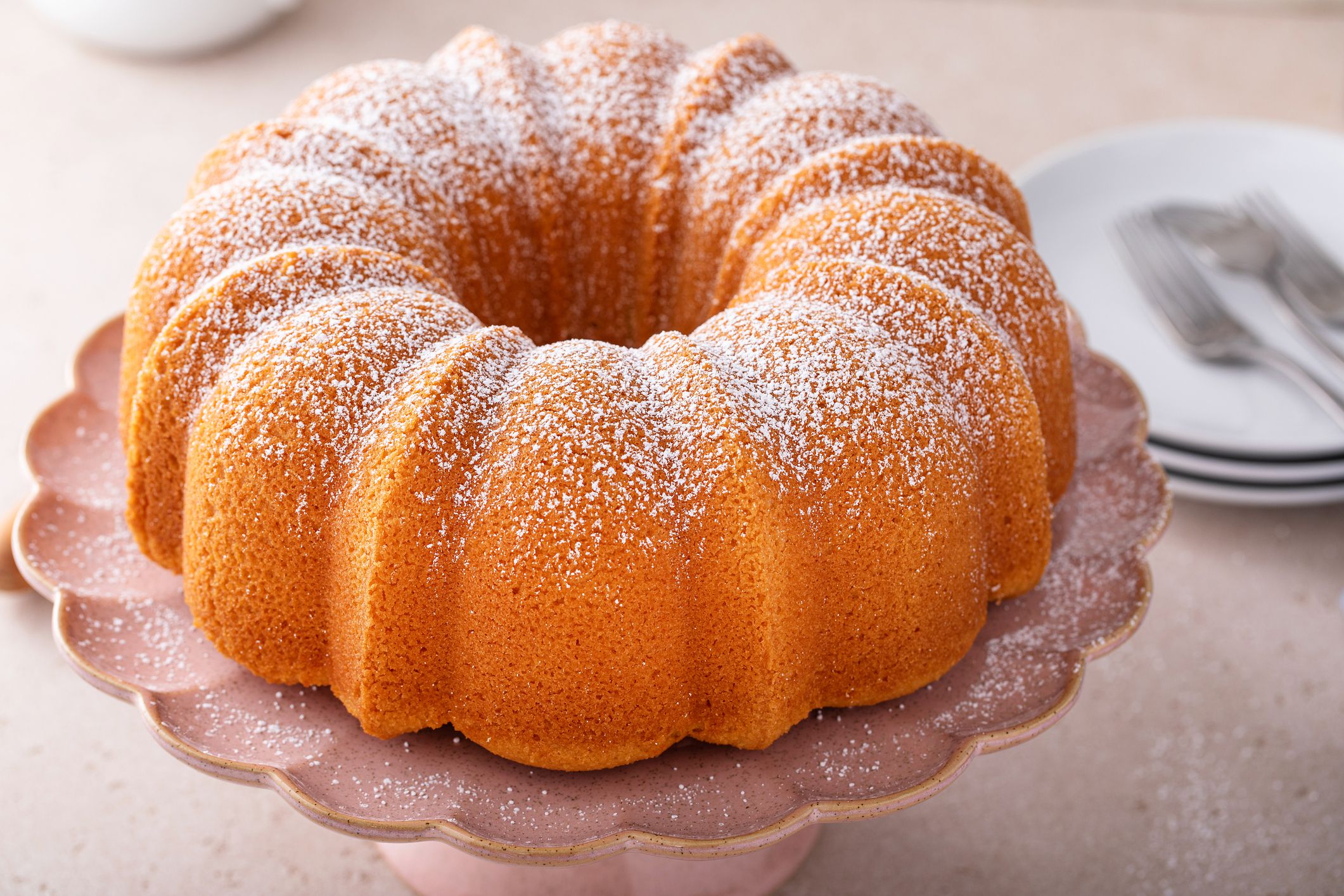 Pound cake baked in a bundt pan, traditional vanilla or sour cream flavor, dusted with powdered sugar