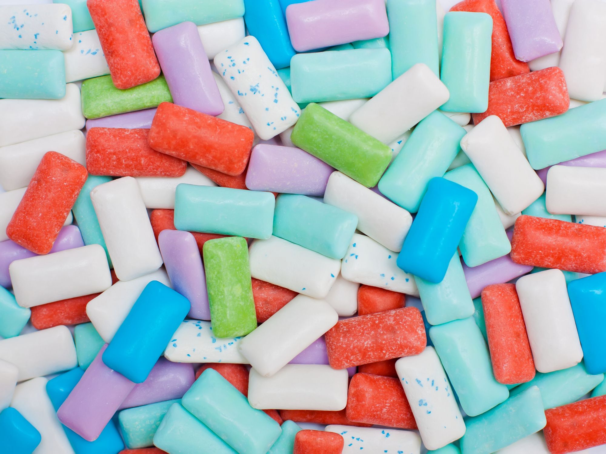 Texture made out of many chewing gum pellets of different colors.