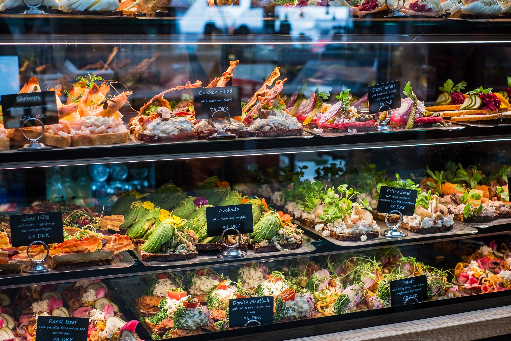 Selection of traditional open-faced sandwich in cuisines of Denmark (Smørrebrød), Norway (smørbrød) and Sweden (smörgås). Consists of buttered rye bread topped with meat or fish, and salads.