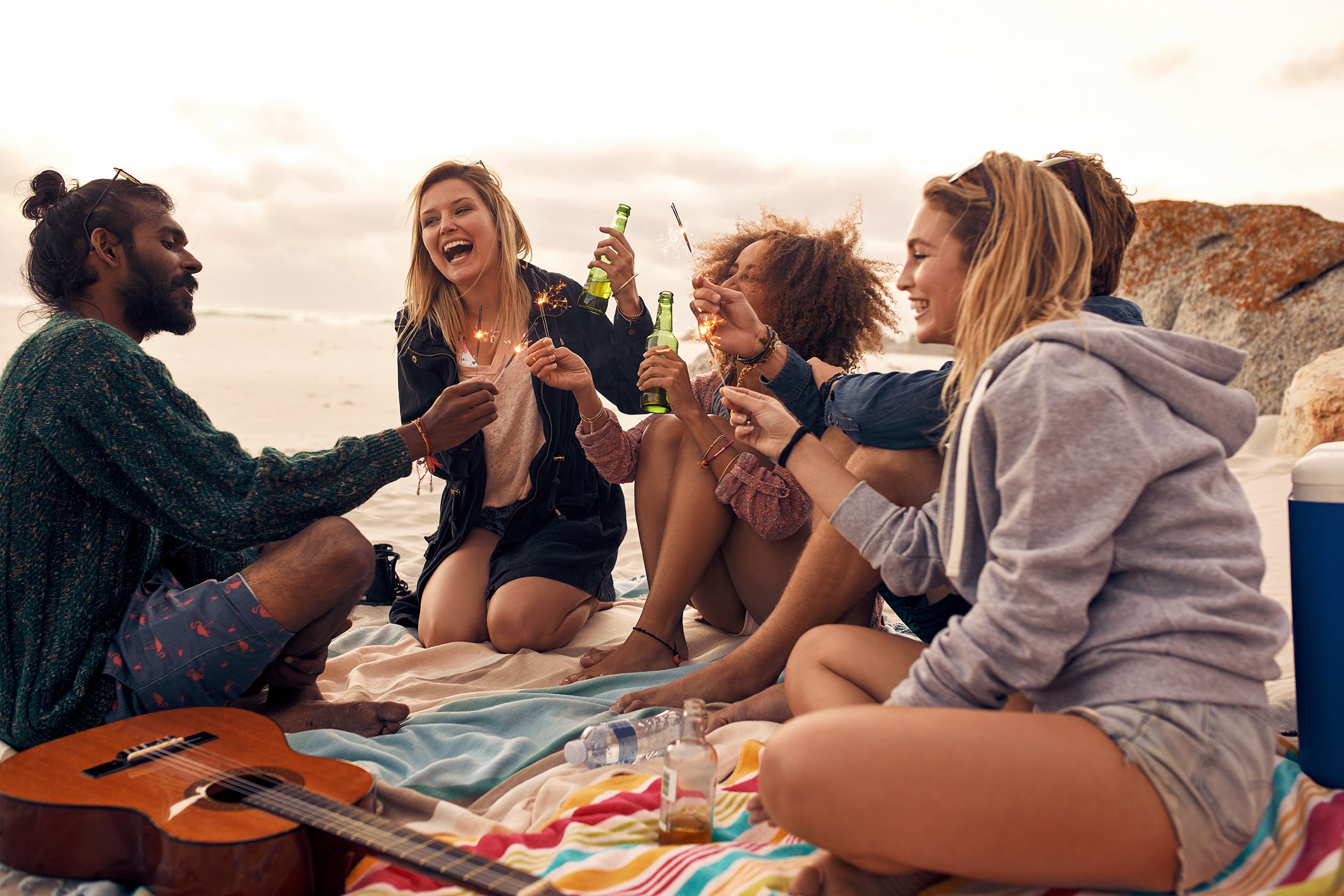happy friends partying on the beach