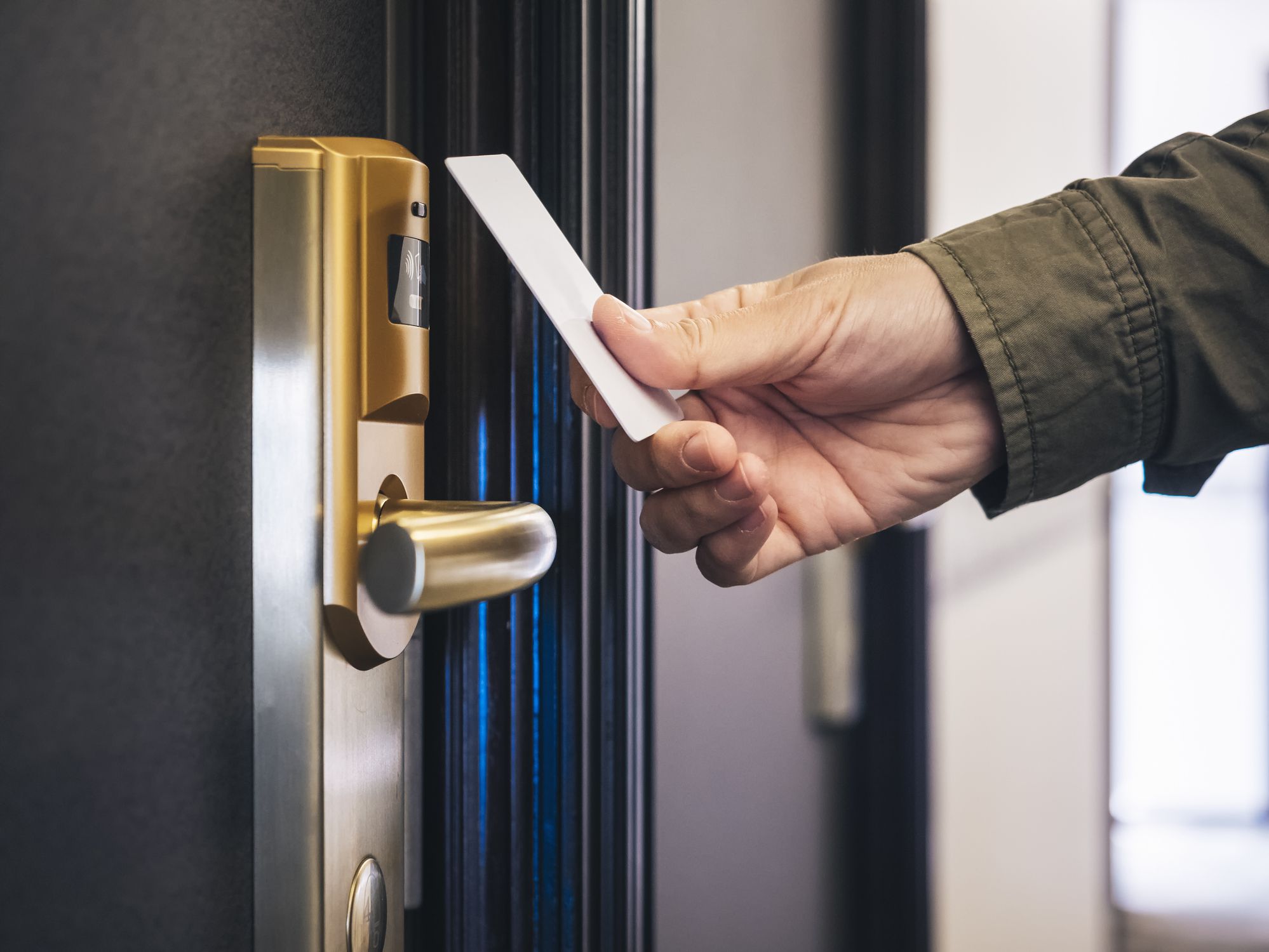 Hand Holding Key card Hotel room access Privacy security gate system