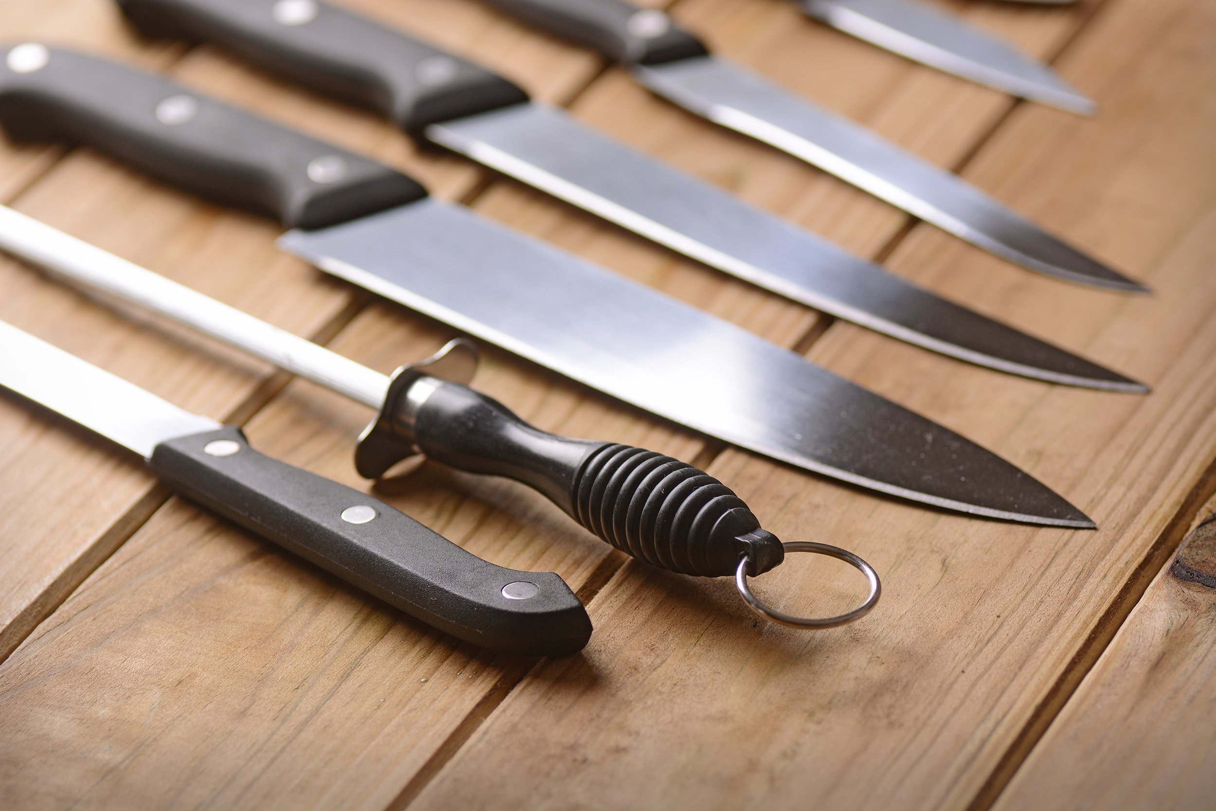 set of kitchen knives on a wooden table