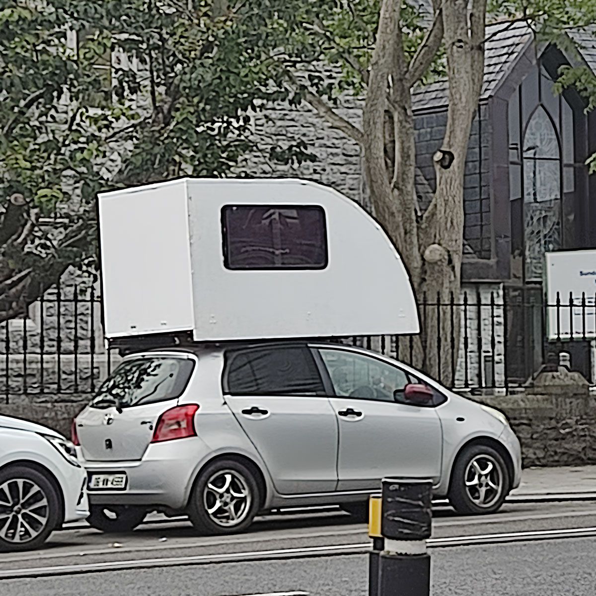 Toyota Yaris with a cabin attached the roof